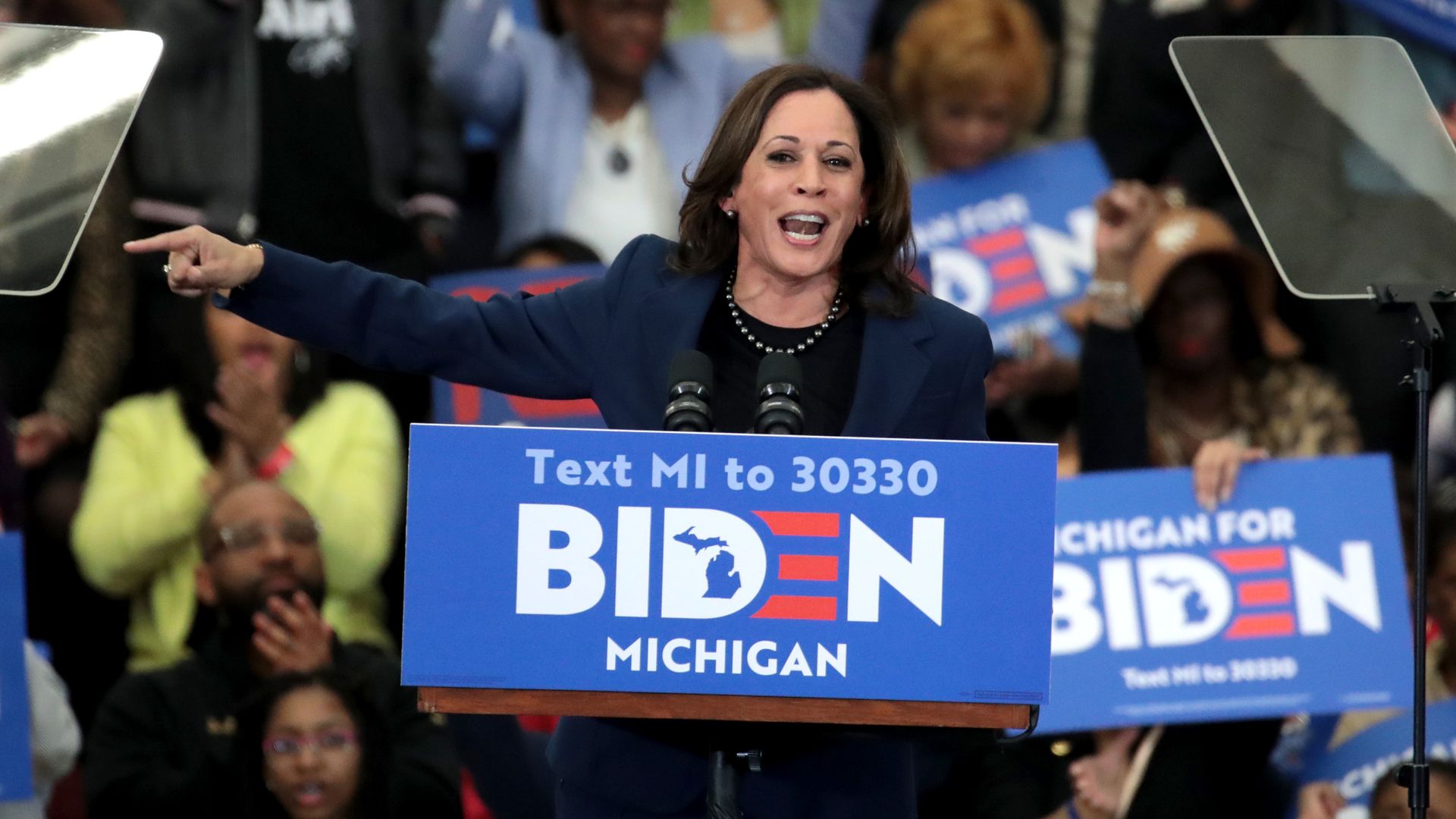 Sen. Kamala Harris passionately speaks at a podium with the Joe Biden campaign sign at an event