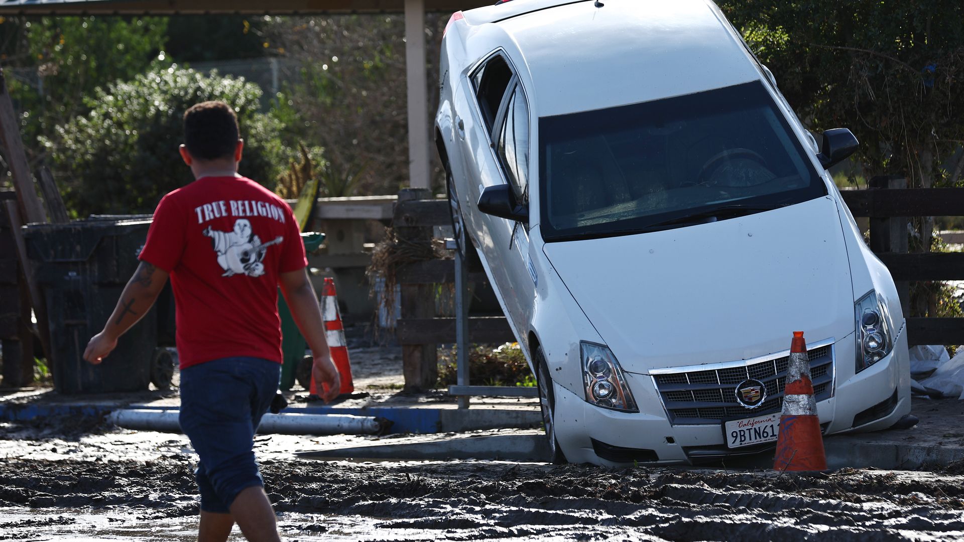A man observes damage from the Jan. 22 San Diego flood