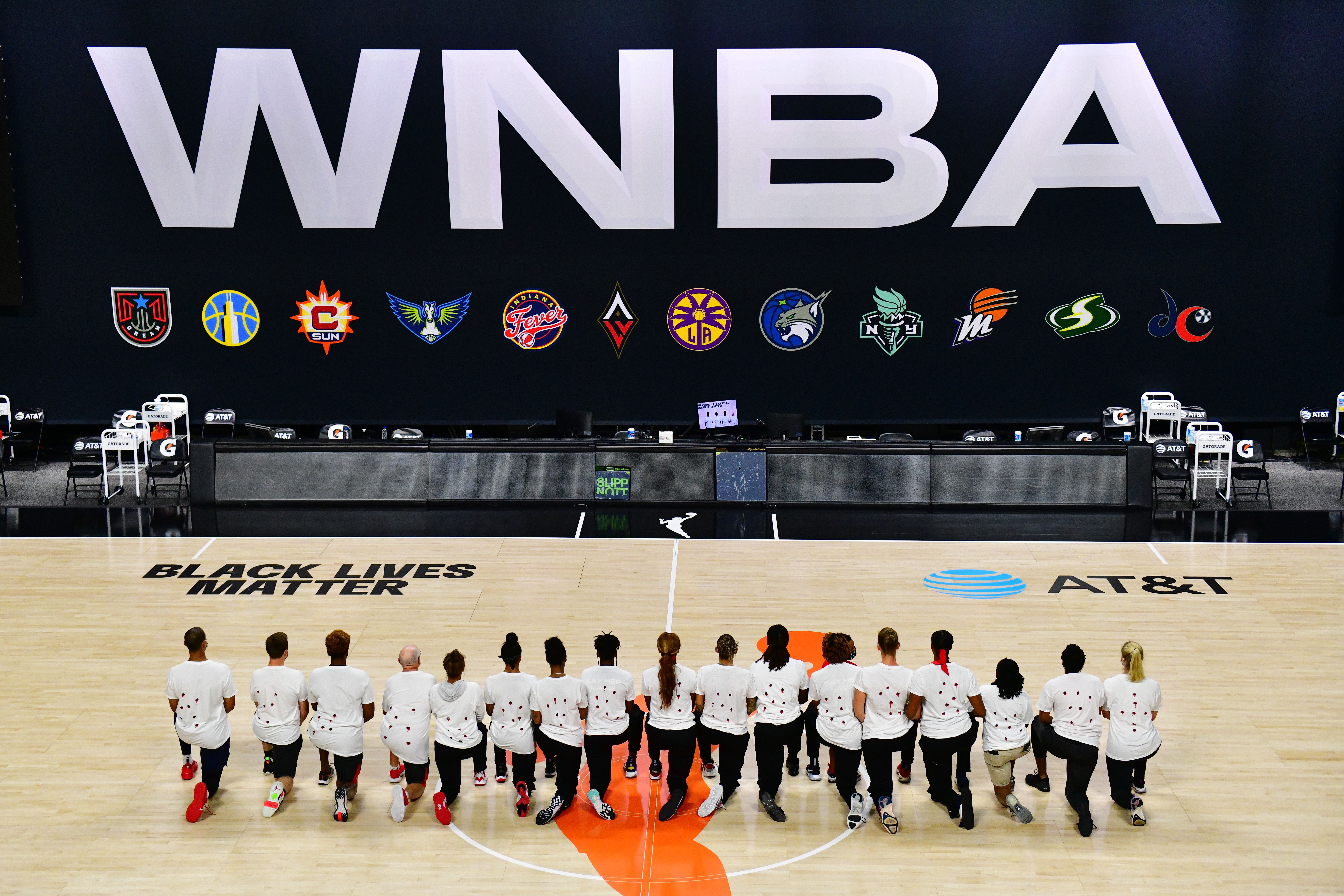 WNBA players kneeling