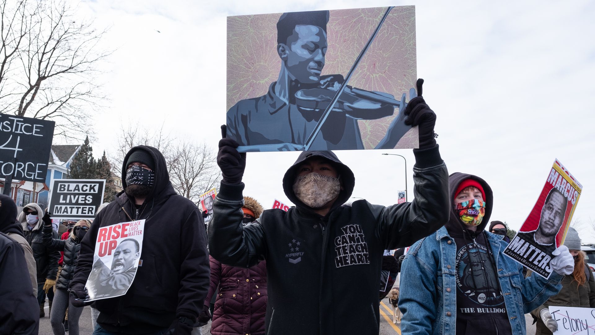 A protester holds a poster of Elijah McClain during a Martin Luther King Jr. Day march in St. Paul. January 18, 2021. (Photo by Tim Evans/NurPhoto via Getty Images)
