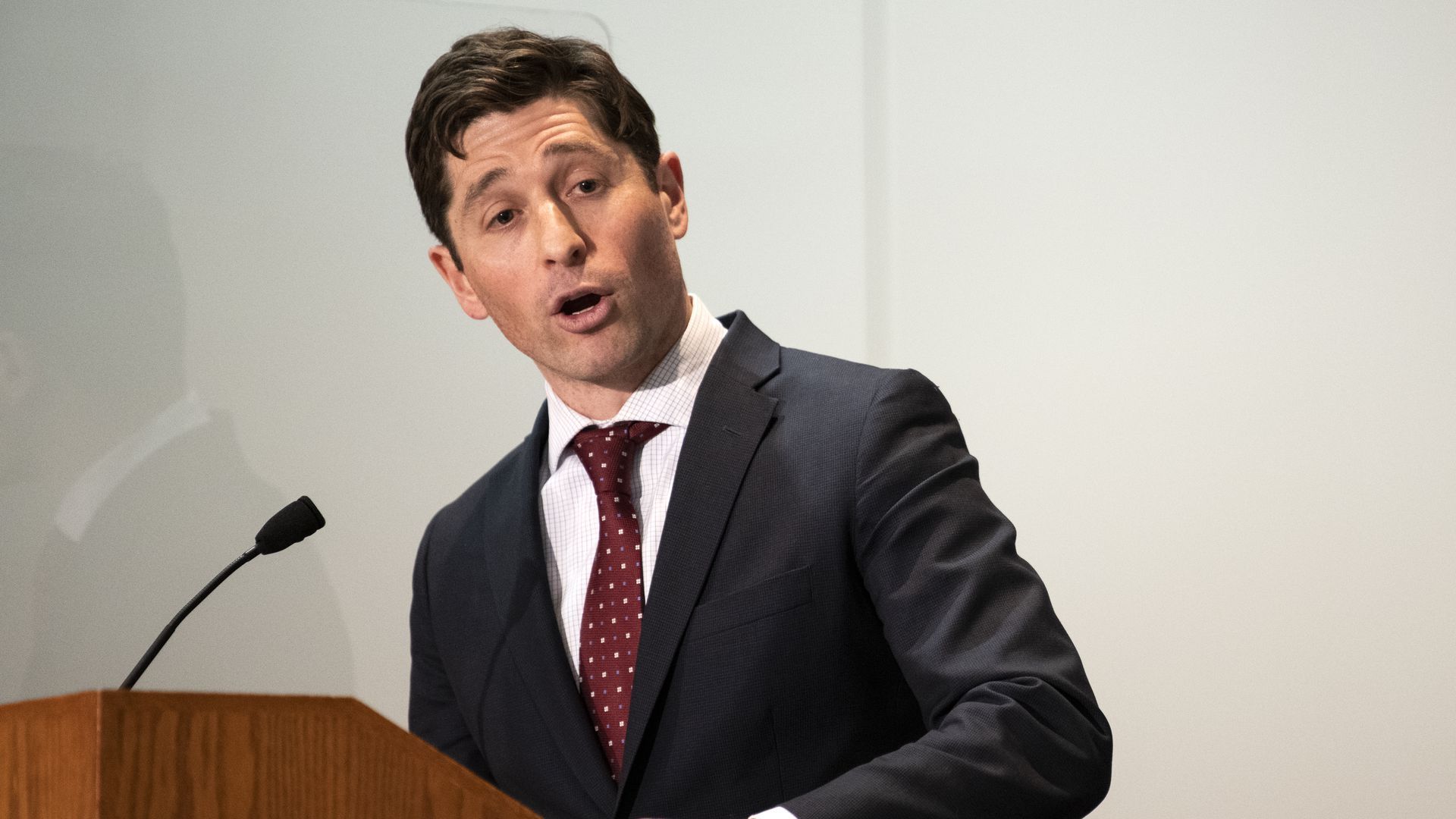 Minneapolis Mayor Jacob Frey stands at a lecturn