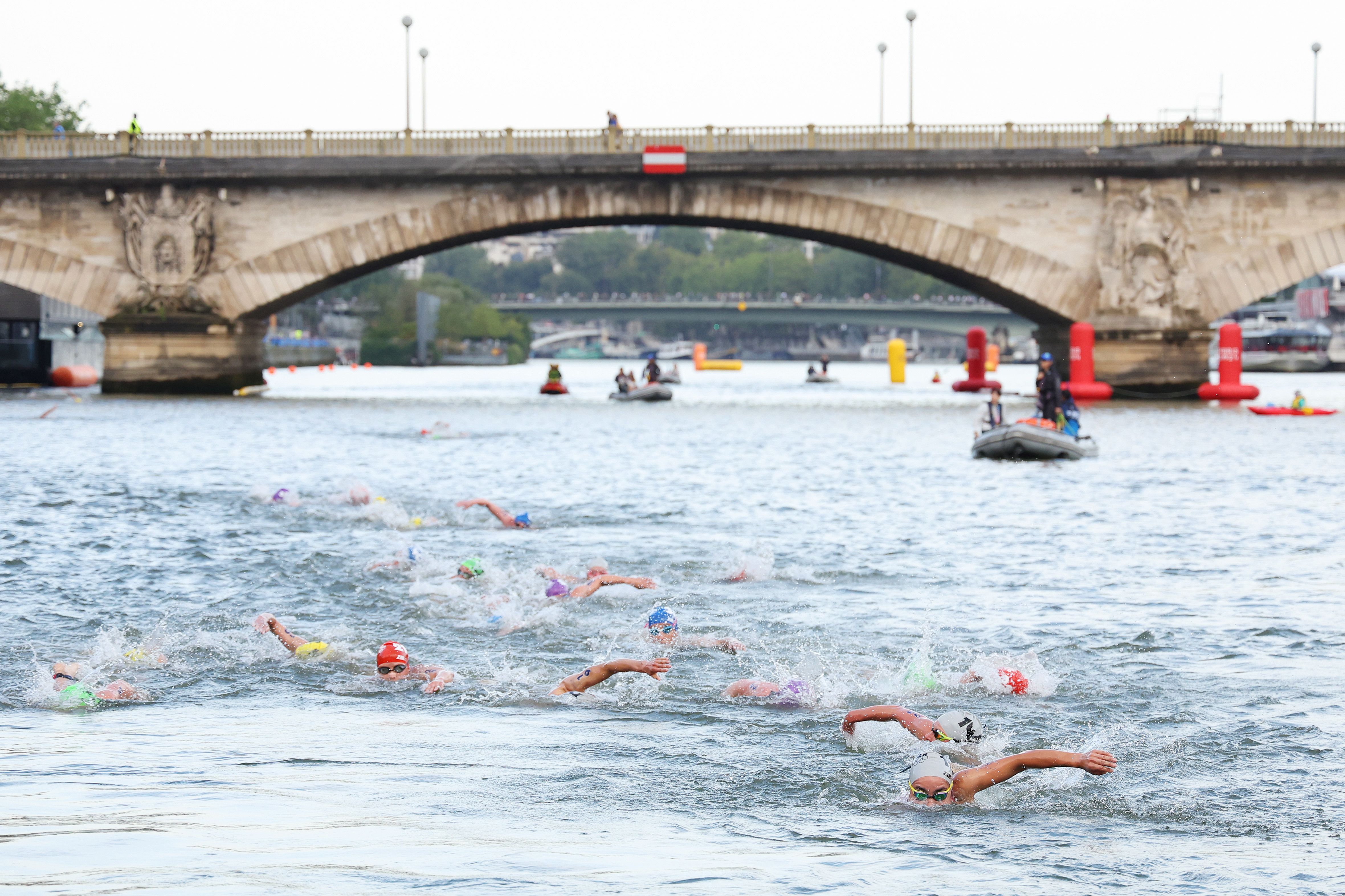 A general view of athletes swimming in the Seine River during Women's Individual Triathlon on day five of the Olympic Games Paris 2024 at Pont Alexandre III on July 31