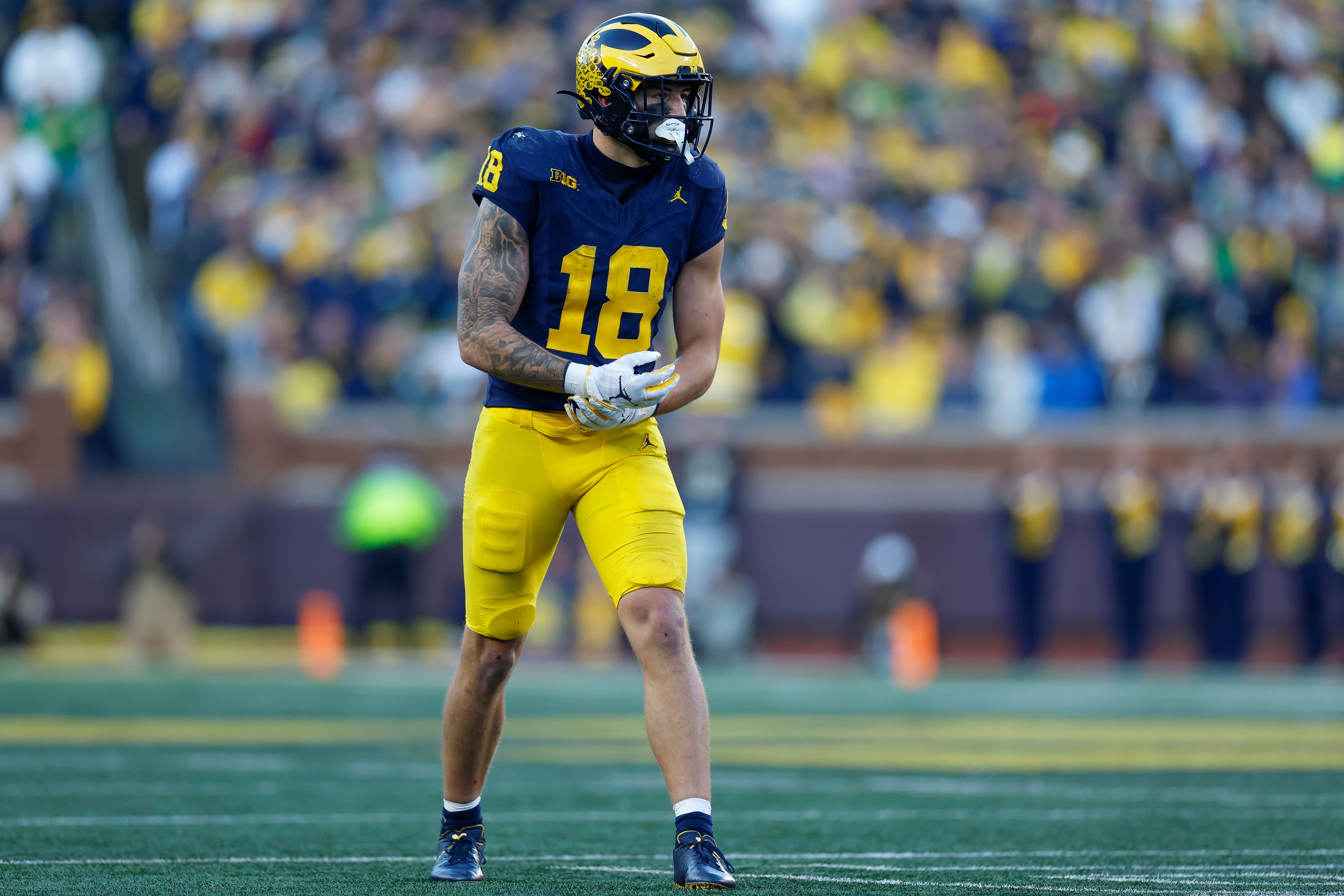 Photo of a football player lined up for a play. 