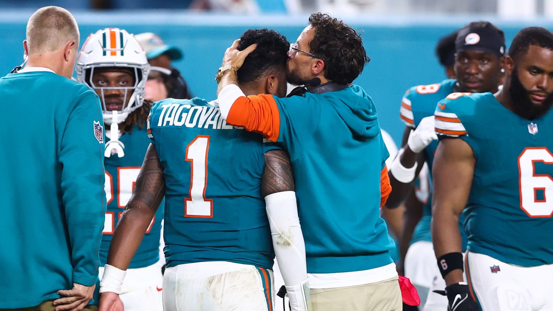 MIAMI GARDENS, FLORIDA - SEPTEMBER 12: Head coach Mike McDaniel of the Miami Dolphins embraces Tua Tagovailoa #1 after leaving the game with an injury during the third quarter against the Buffalo Bills at Hard Rock Stadium on September 12, 2024 in Miami Gardens, Florida.