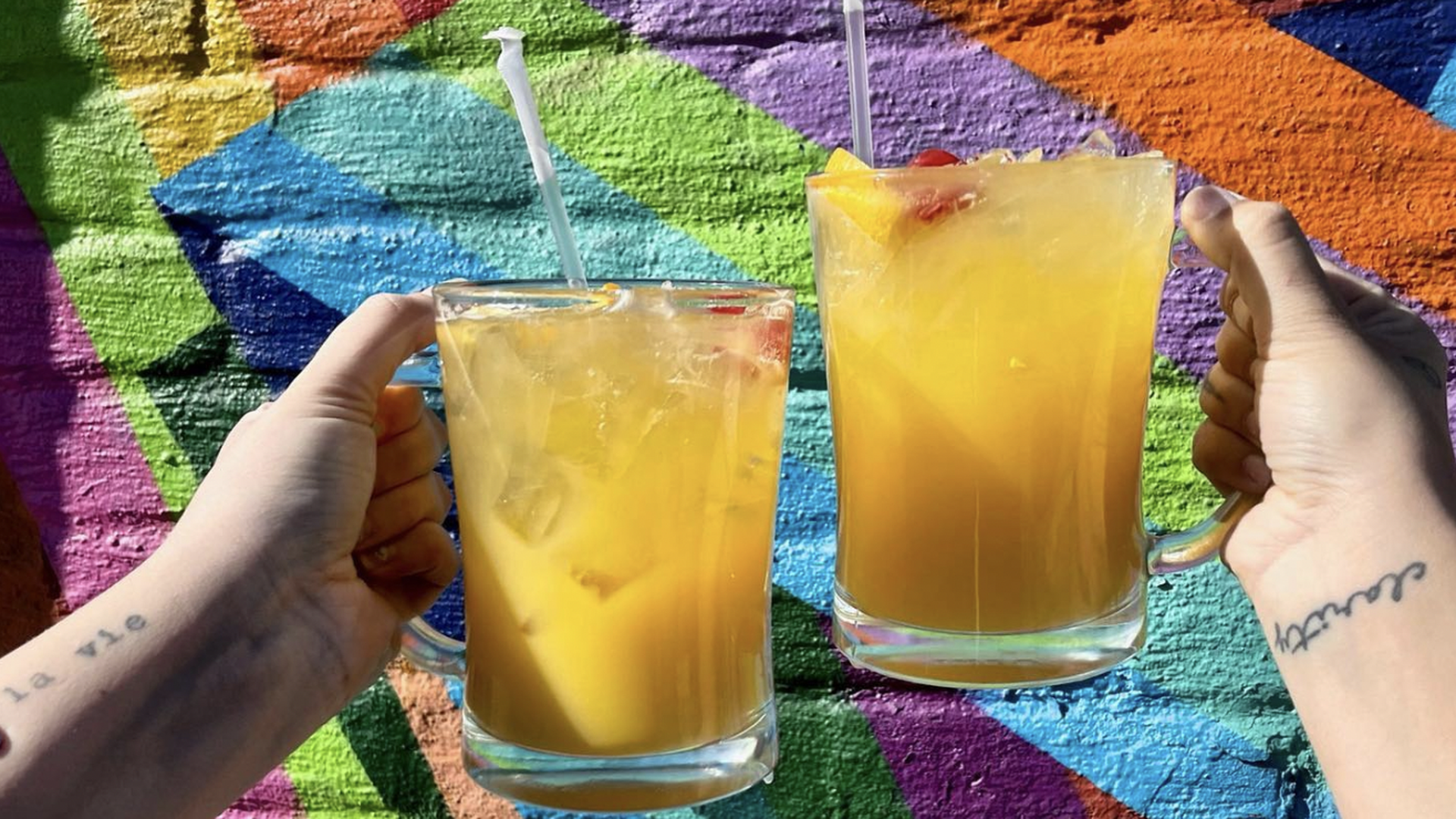 Two people share a cocktail at Bobcat Bonnie's in Detroit