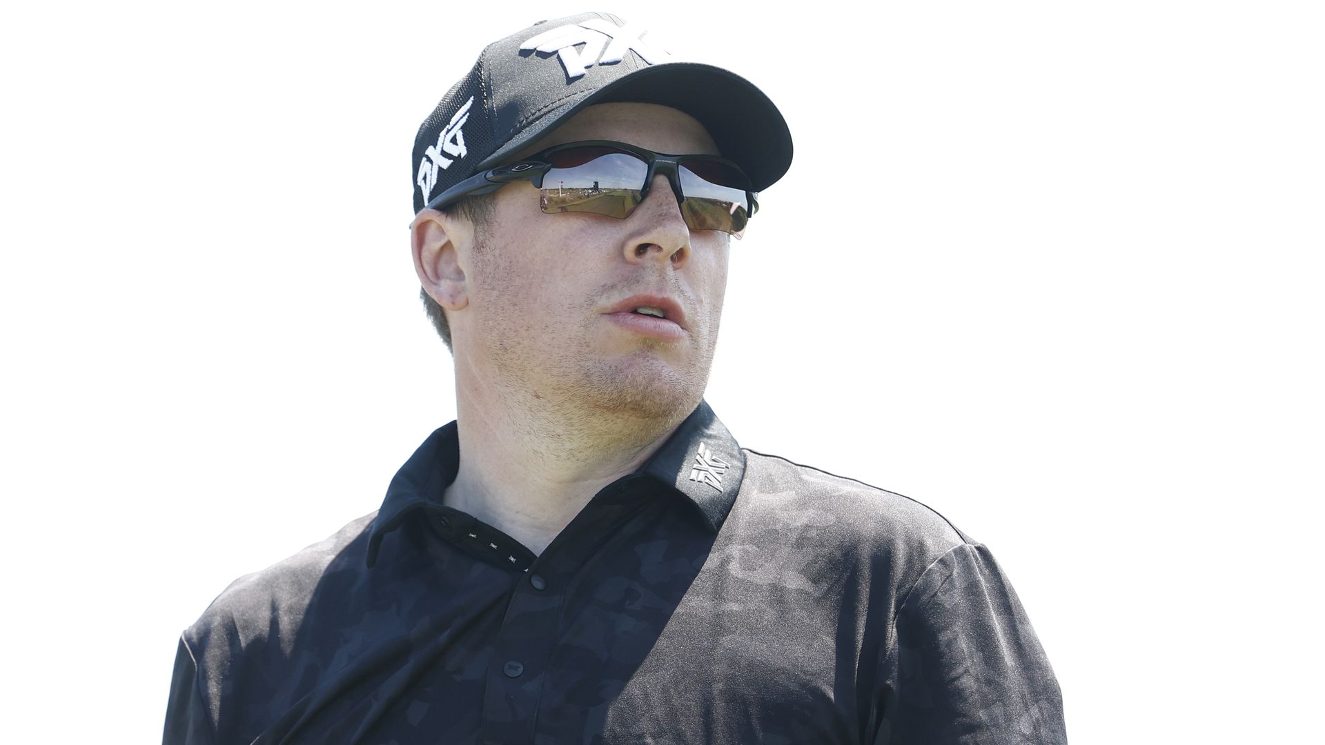 Derek Holmes wears a black shirt and black sunglasses 