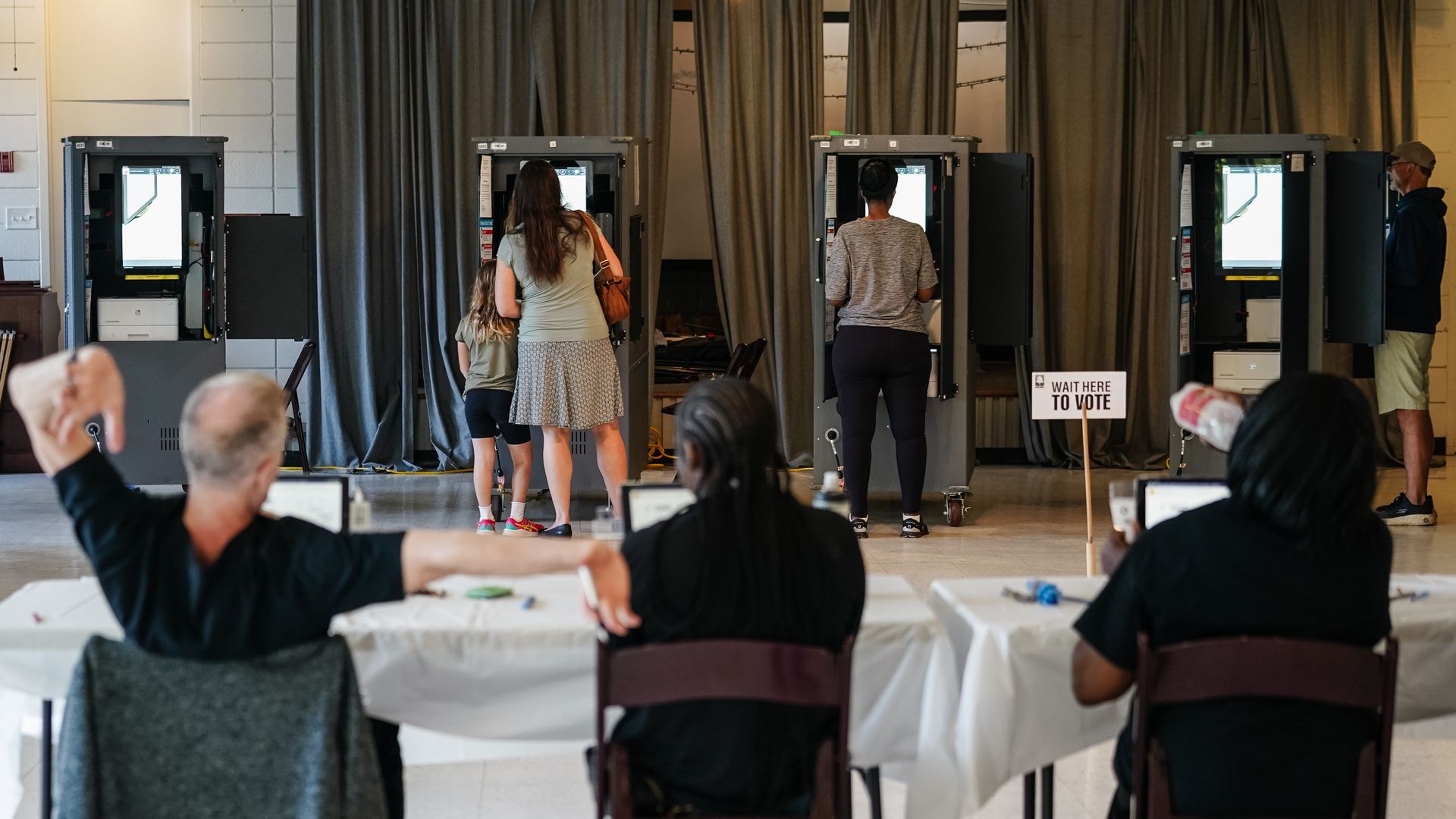 A Fulton County Elections worker stretches his arms as voters cast ballots in Georgia's primary election at a polling location on May 21, 2024 in Atlanta, Georgia. Among the races on the ballot in Fulton County is Scott McAfee, the Fulton County Superior Court Judge overseeing former president Donal