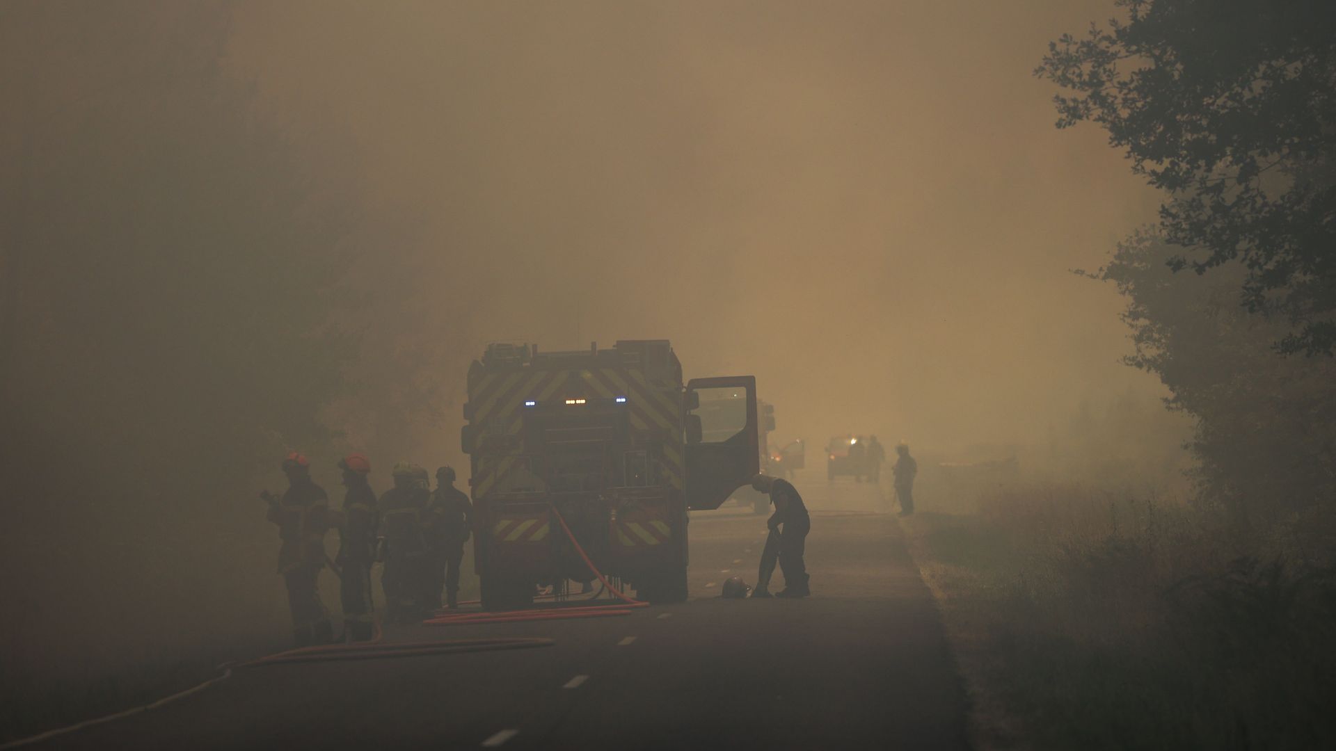 Firefighters try to control a forest fire near Louchats in Gironde, southwestern France on July 17.
