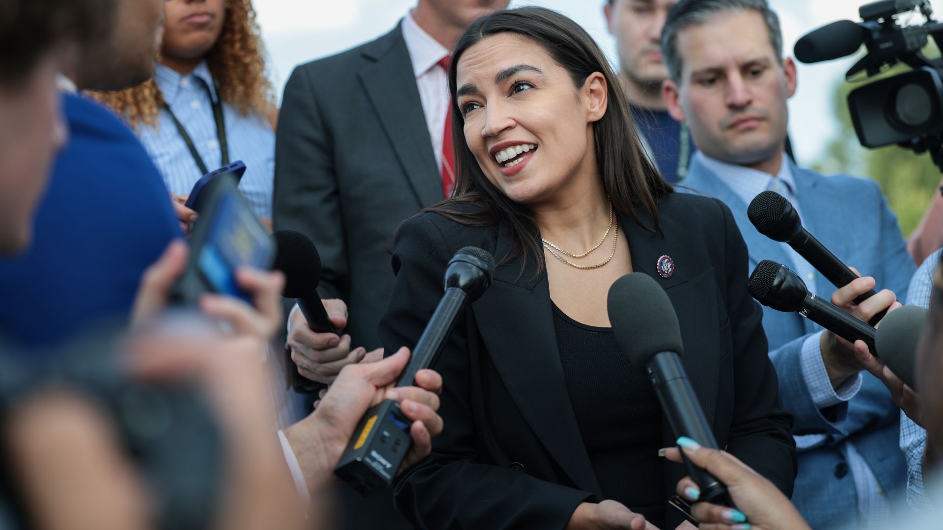 Rep. Alexandria Ocasio-Cortez speaks to reporters gathered around her outside the U.S. Capitol.