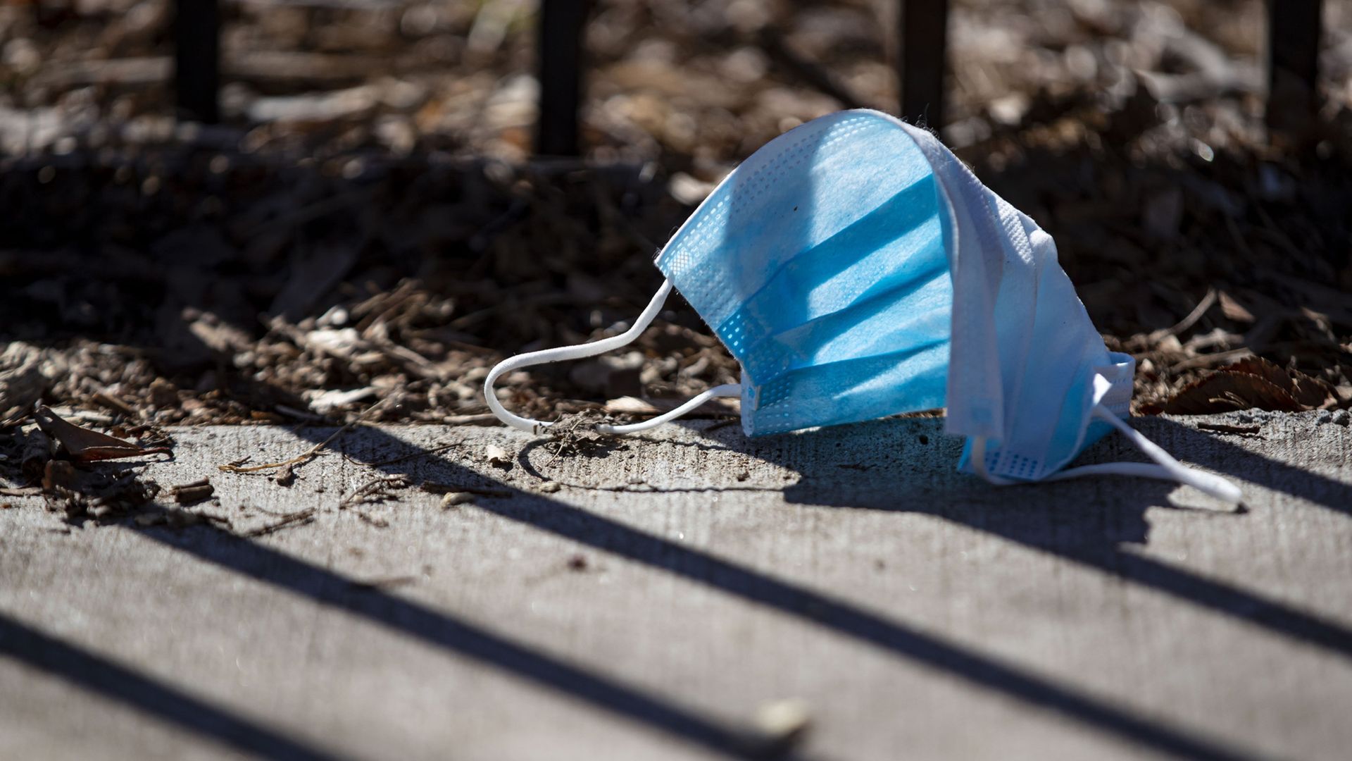 Photo of a disposable mask on the ground. 