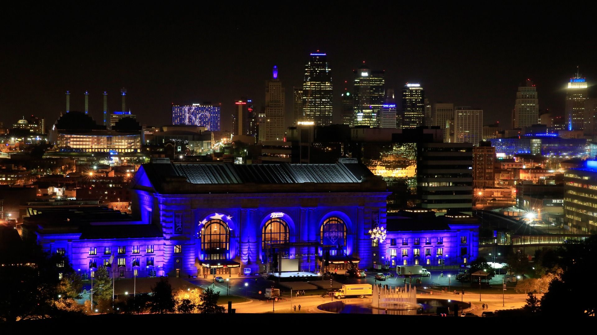 Union Station is lit up with blue lights in front of the Kansas City skyline ahead of a parade and celebration in honor of the Kansas City Royals' World Series win.