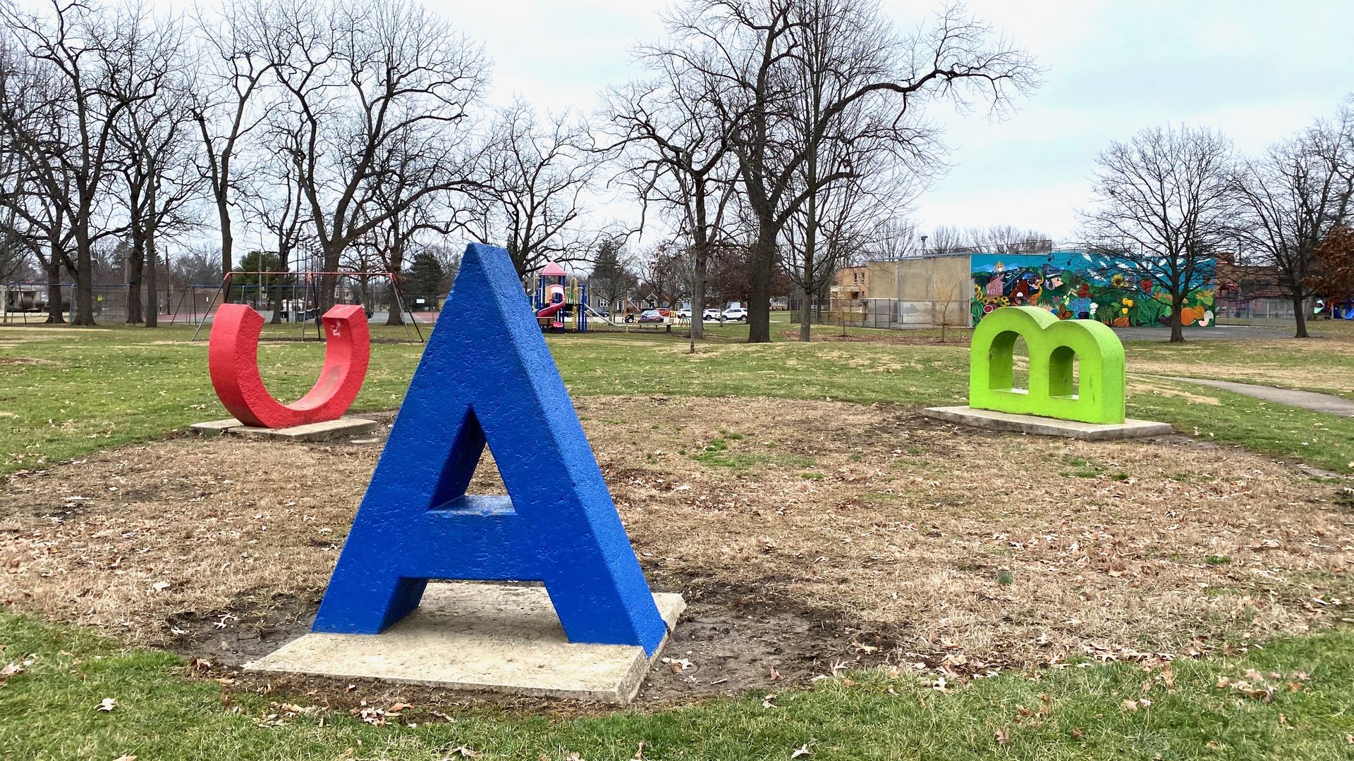 Large sculptures of a blue "A" straight up and a green "B" and red "C" on their sides