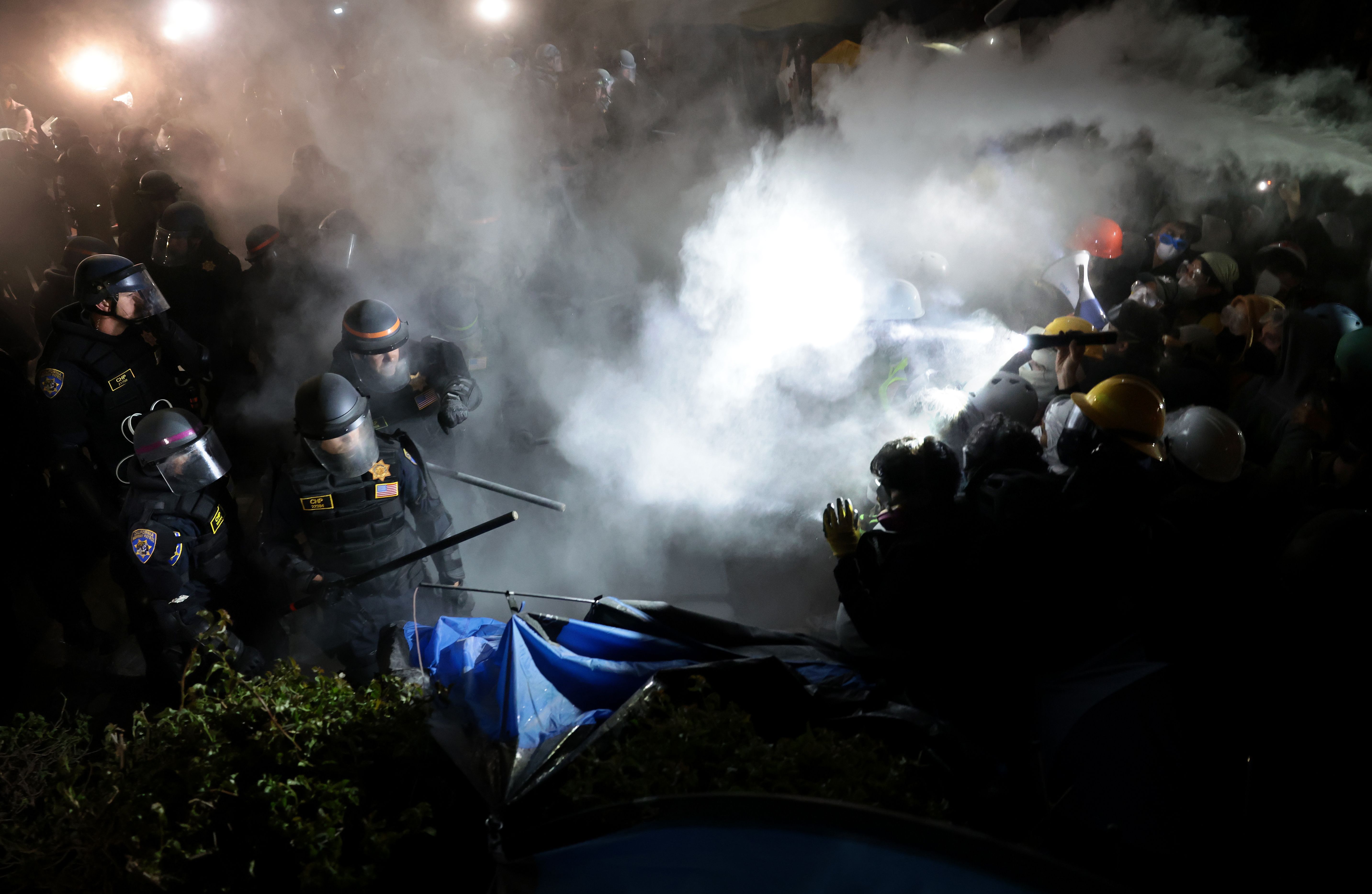 A fire extinguisher is deployed as police clash with pro-Palestinian protesters at UCLA early yesterday.