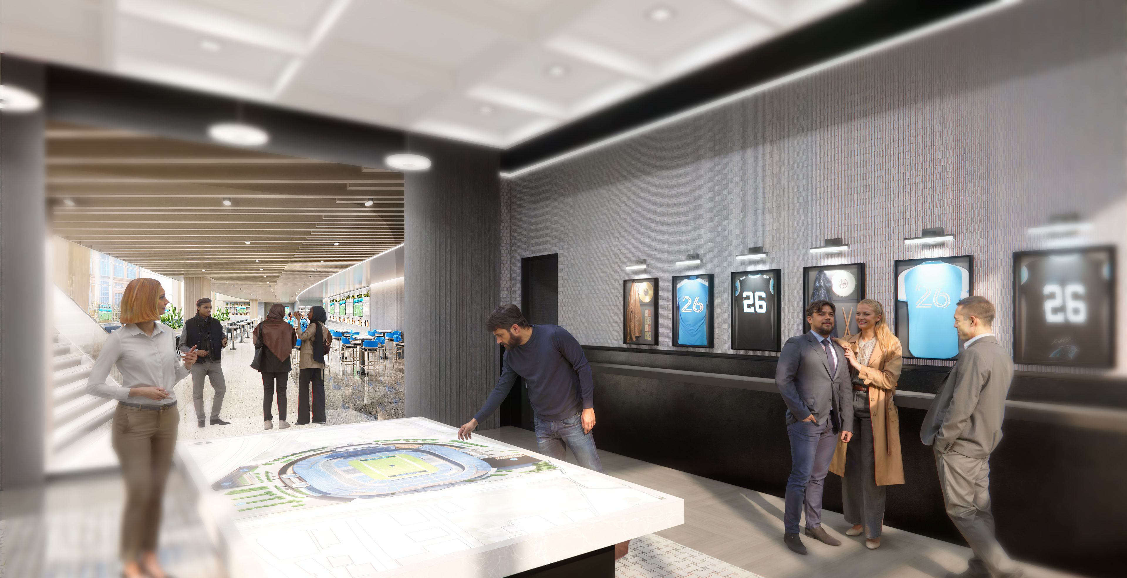 Modern indoor space with several people in business casual attire, a man examining a large table model of a stadium, and framed sports jerseys numbered 26 displayed on a textured wall.