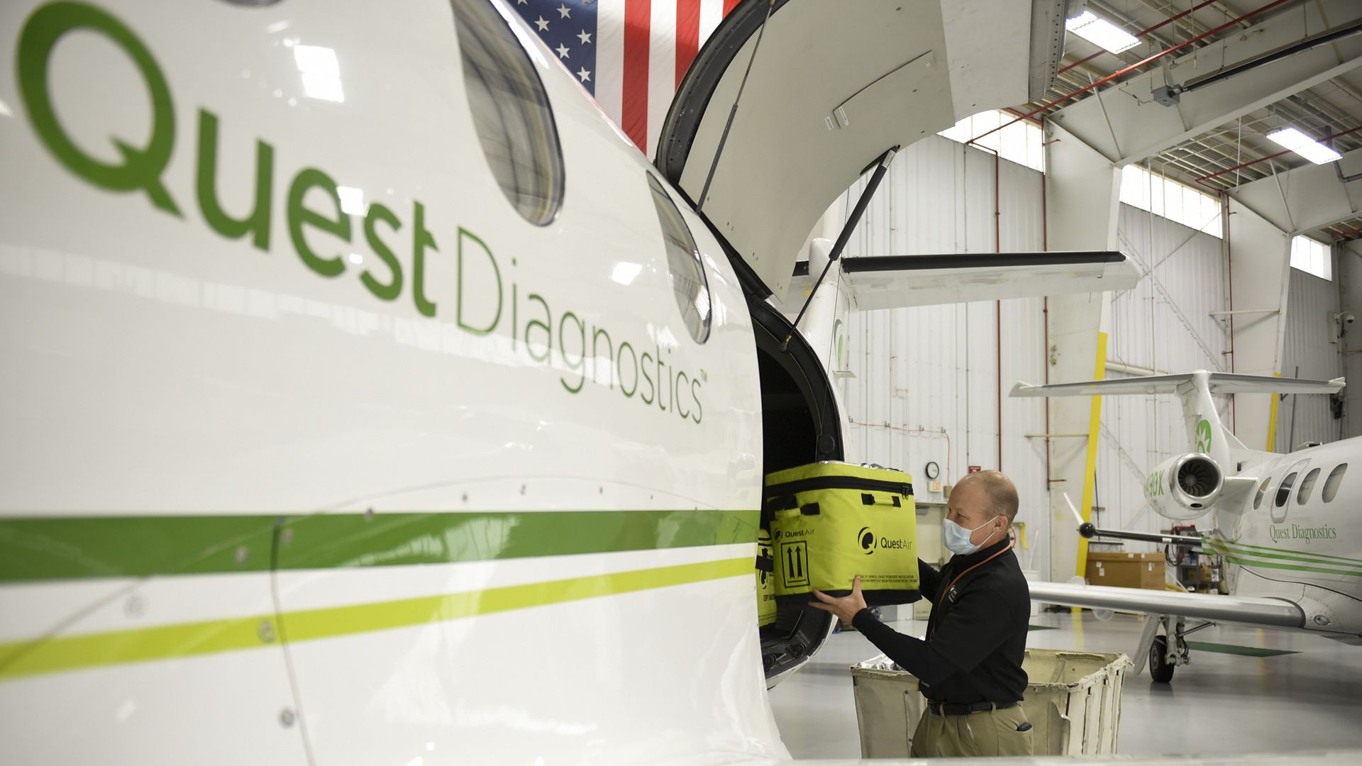 A man loads coronavirus tests onto a Quest Diagnostics airplane.