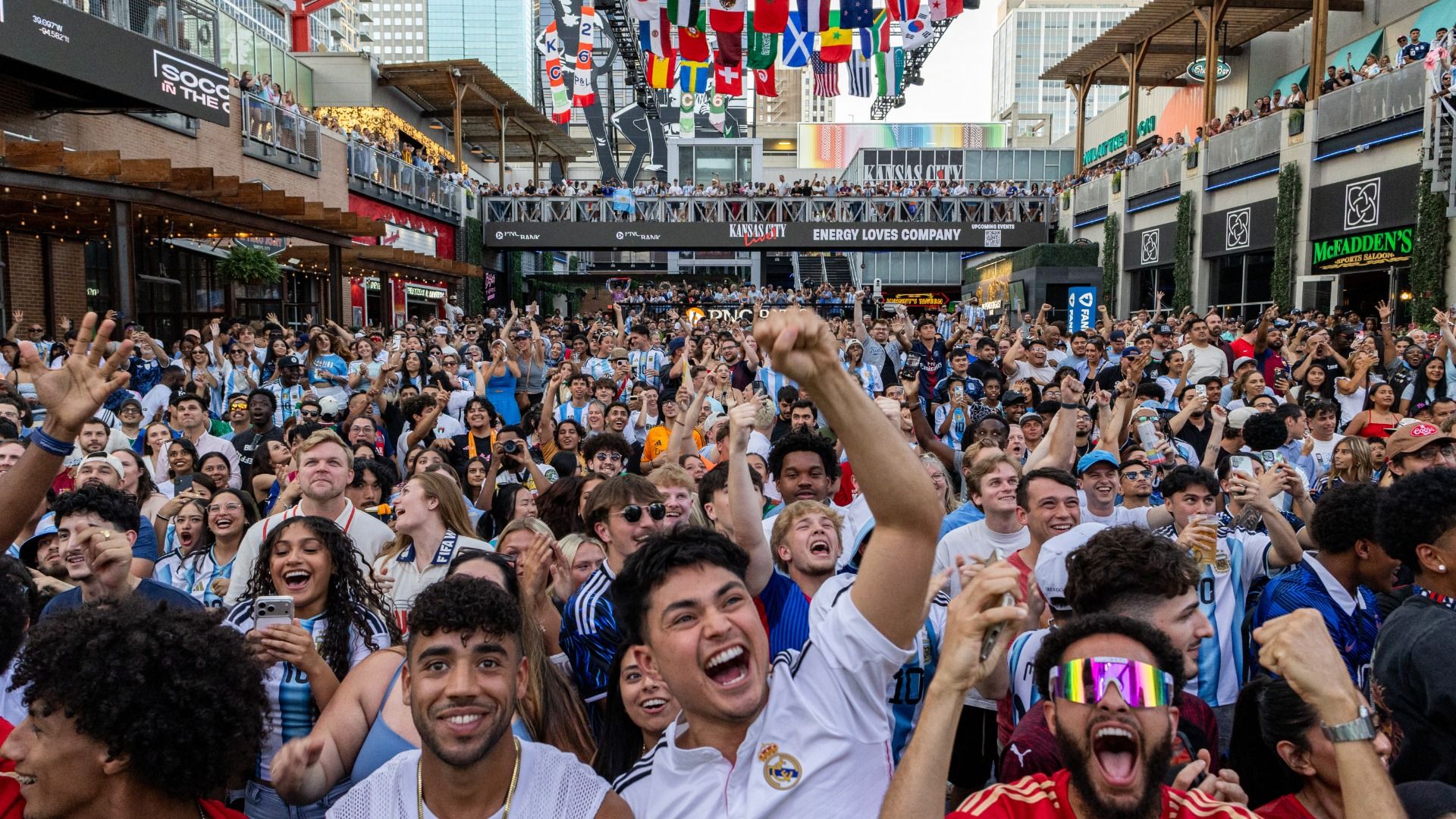 Football fans celebrate a goal scored by Algeria that was later disallowed as they watch the 2026 World Cup football tournament match between Argentina and Algeria at the Power & Light District in Kansas City, Missouri, on June 16, 2026.