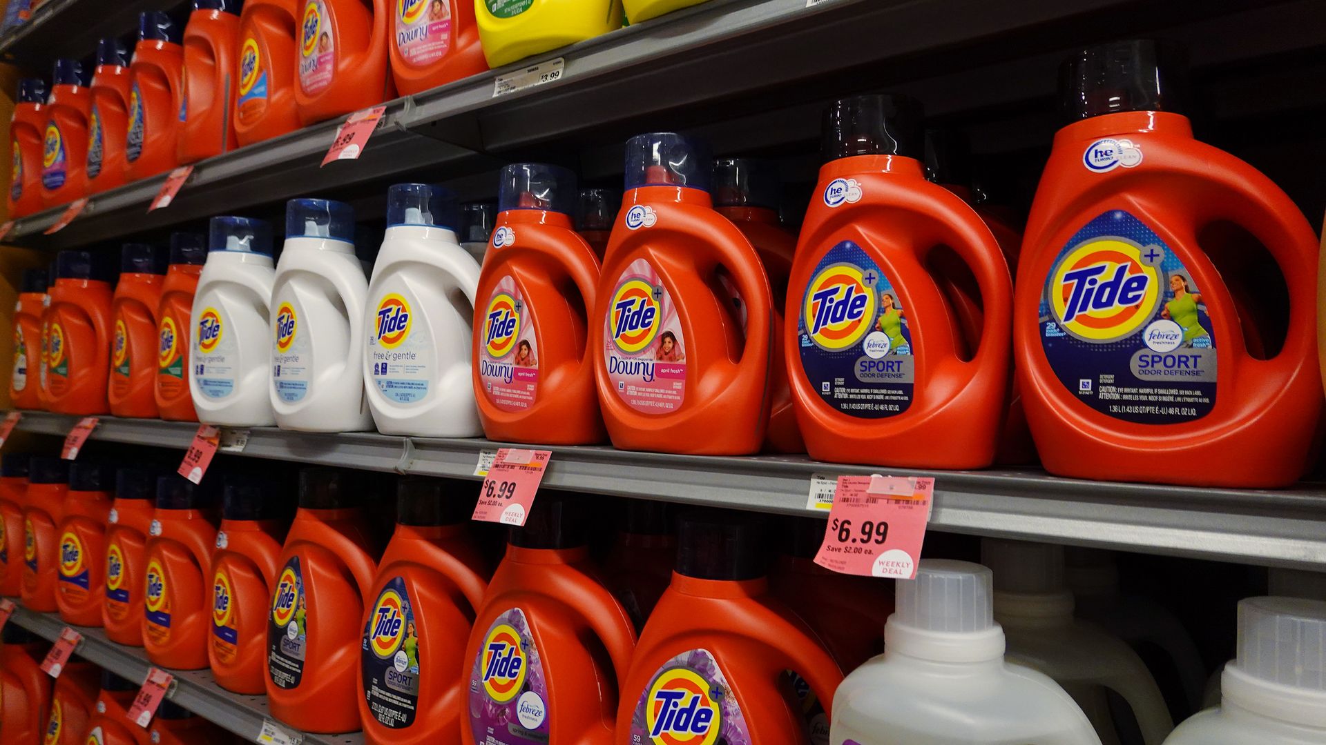 Rows of Tide detergent bottles at a grocery store