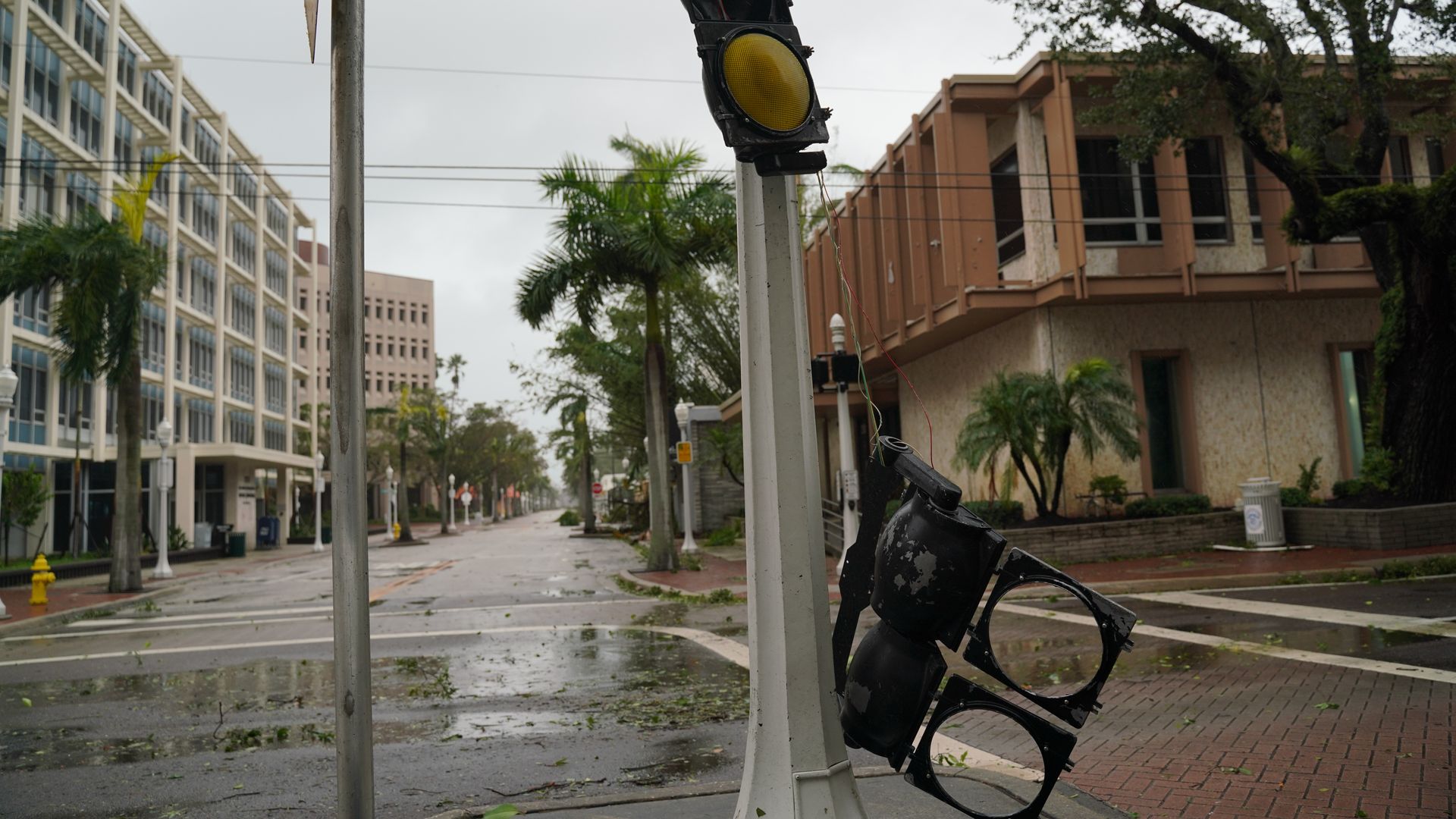 A traffic light is torn in half in a Florida street after Hurricane Ian swept through Wednesday.