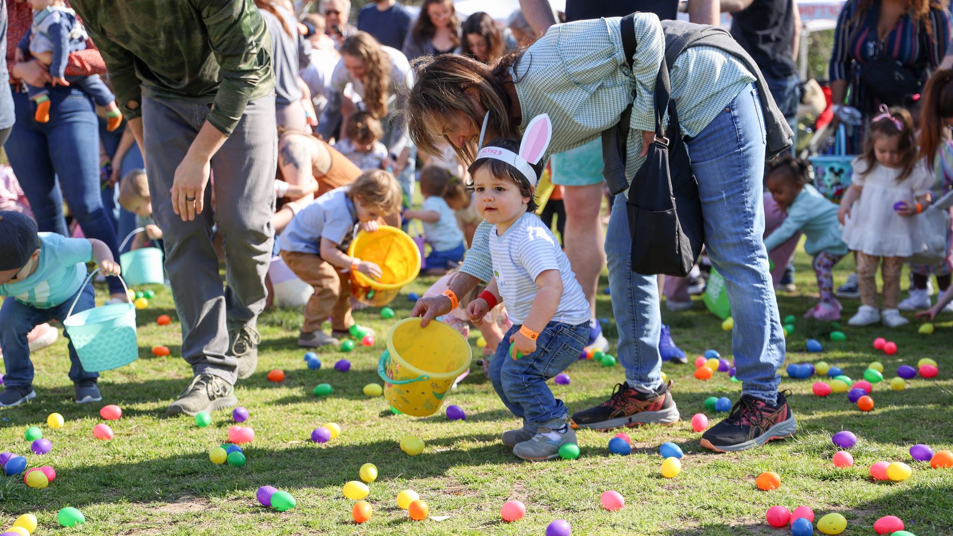 A child running to grab eggs during an easter egg hunt.