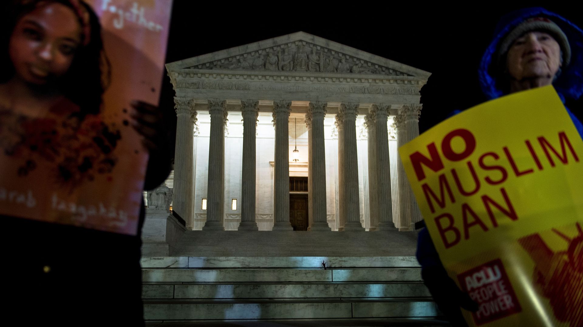 People protest President Trump's travel ban outside the Supreme Court