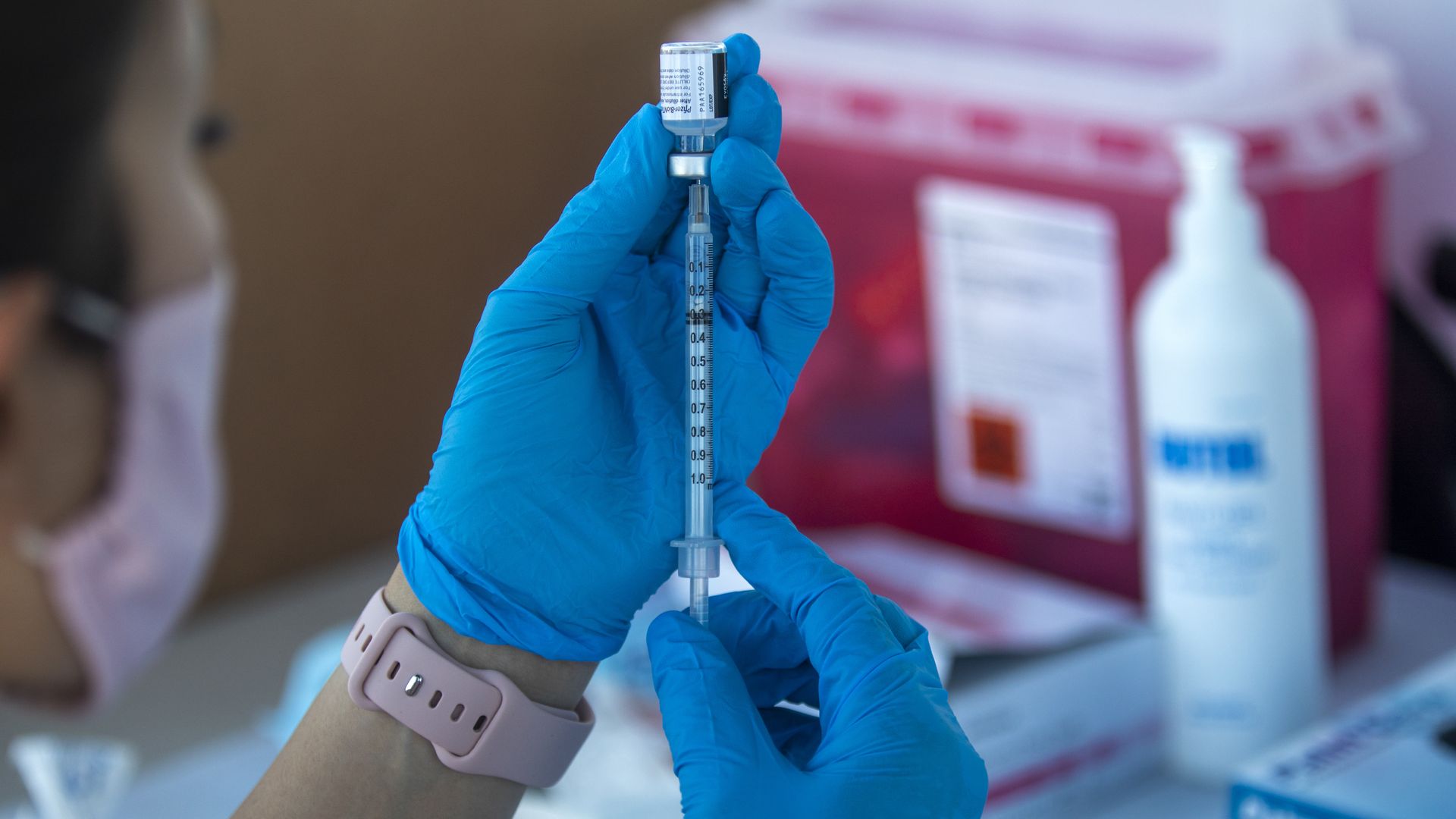 Picture of a health worker holding a Pfizer vaccine
