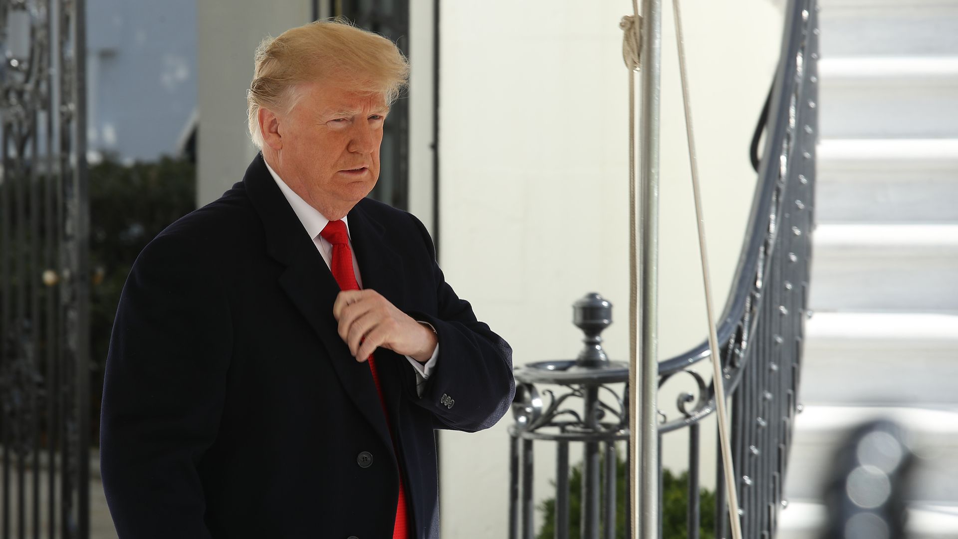 U.S. President Donald Trump walks toward a group of reporters to answer questions while departing for the G-20 summit in Buenos Aires