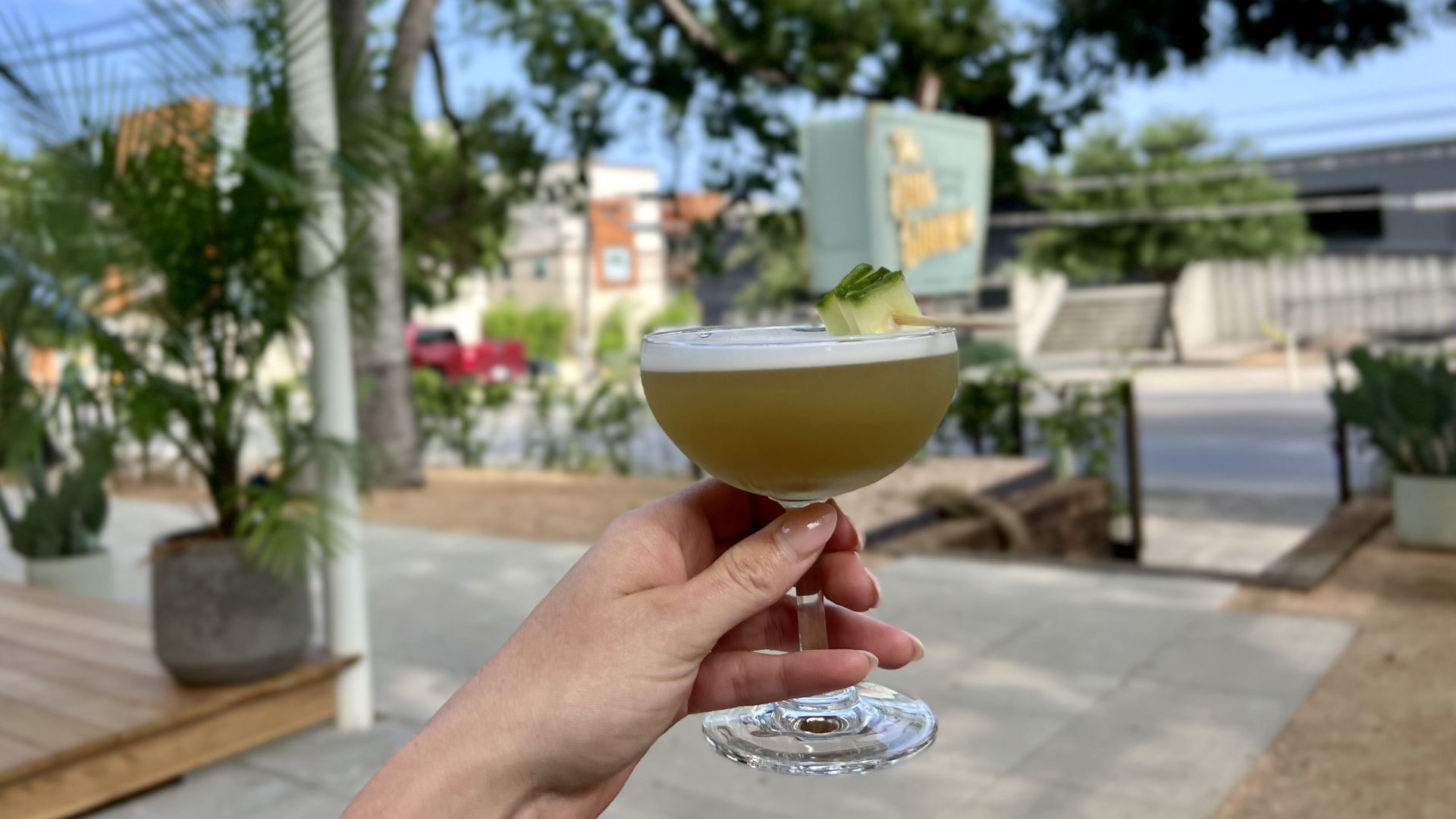 A photo of a hand holding a cocktail.