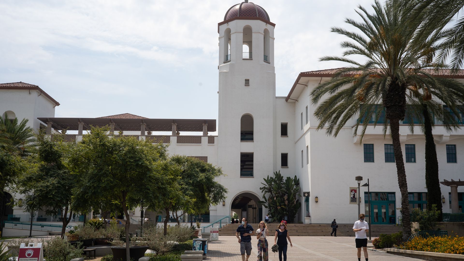 Students and parents walk on campus during move-in day at San Diego State University in San Diego, California, U.S., on Friday, Aug. 21