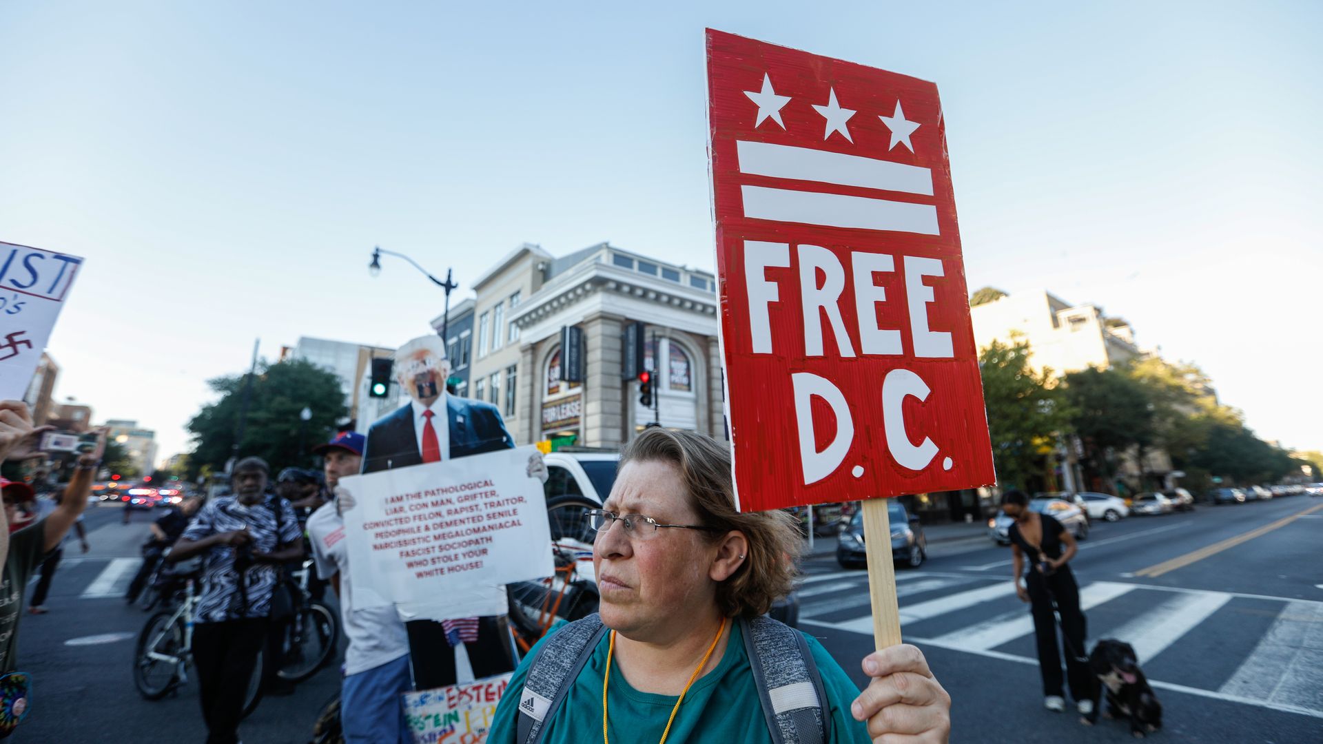 A woman holds a "Free D.C." protest sign at a rally 