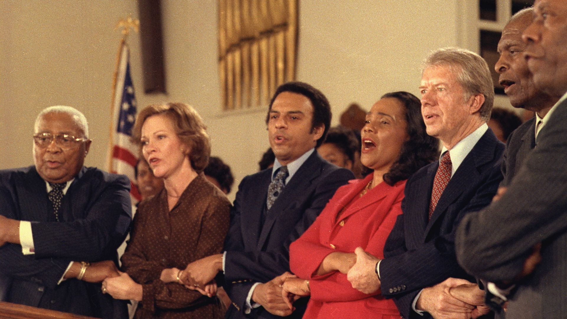 Jimmy Carter and Rosalynn Carter sing with Martin Luther King Sr., Coretta Scott King, Andrew Young and other civil rights leaders during a visit to Ebenezer Baptist Church in Atlanta