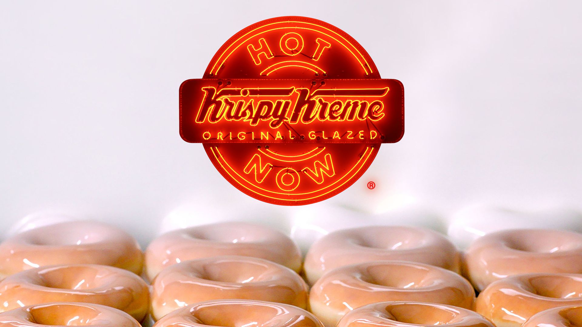 Krispy Kreme glazed doughnuts with Krispy Kreme hot light sign