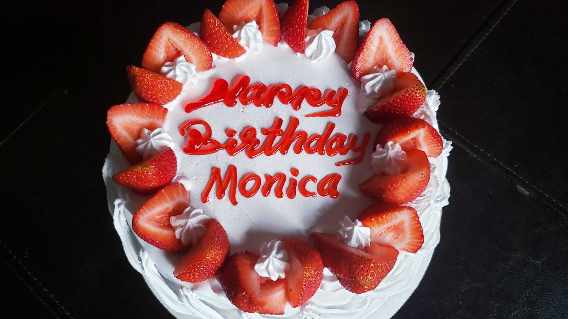 Photo of a birthday cake with strawberries.