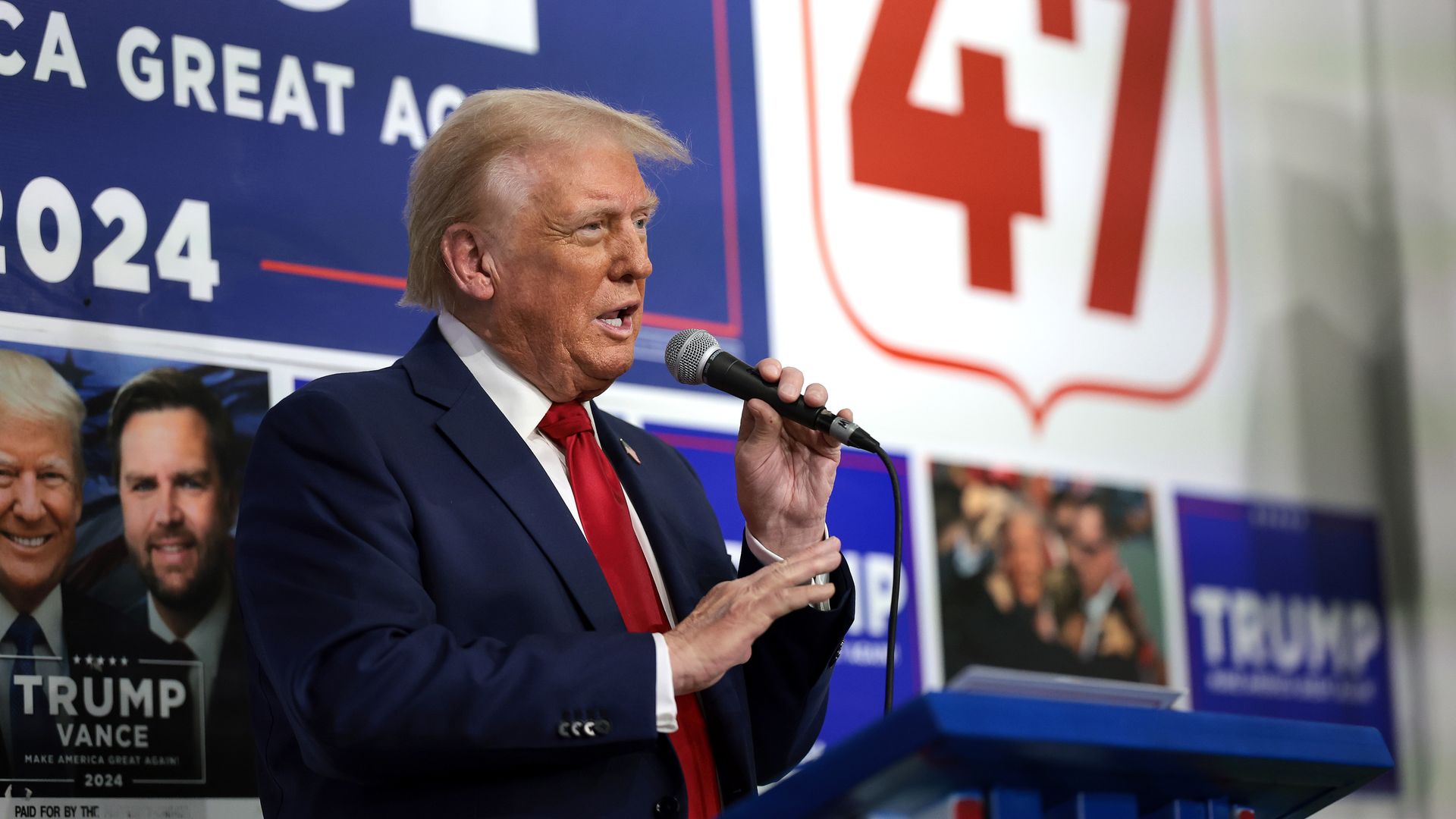 Former President Trump speaks to supporters and staff as he visits a campaign office.