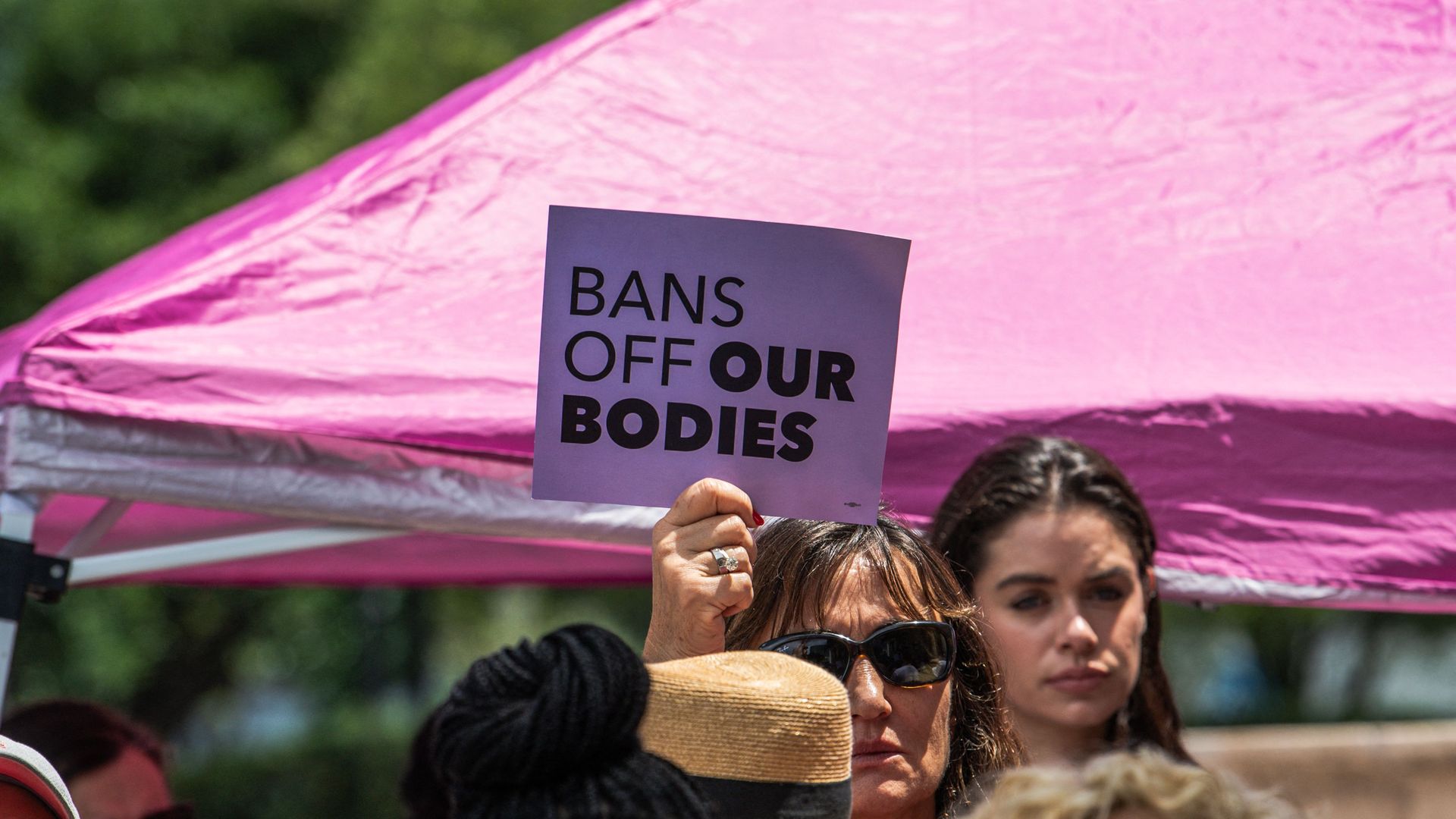 Picture of a sign that says "bans off our bodies"