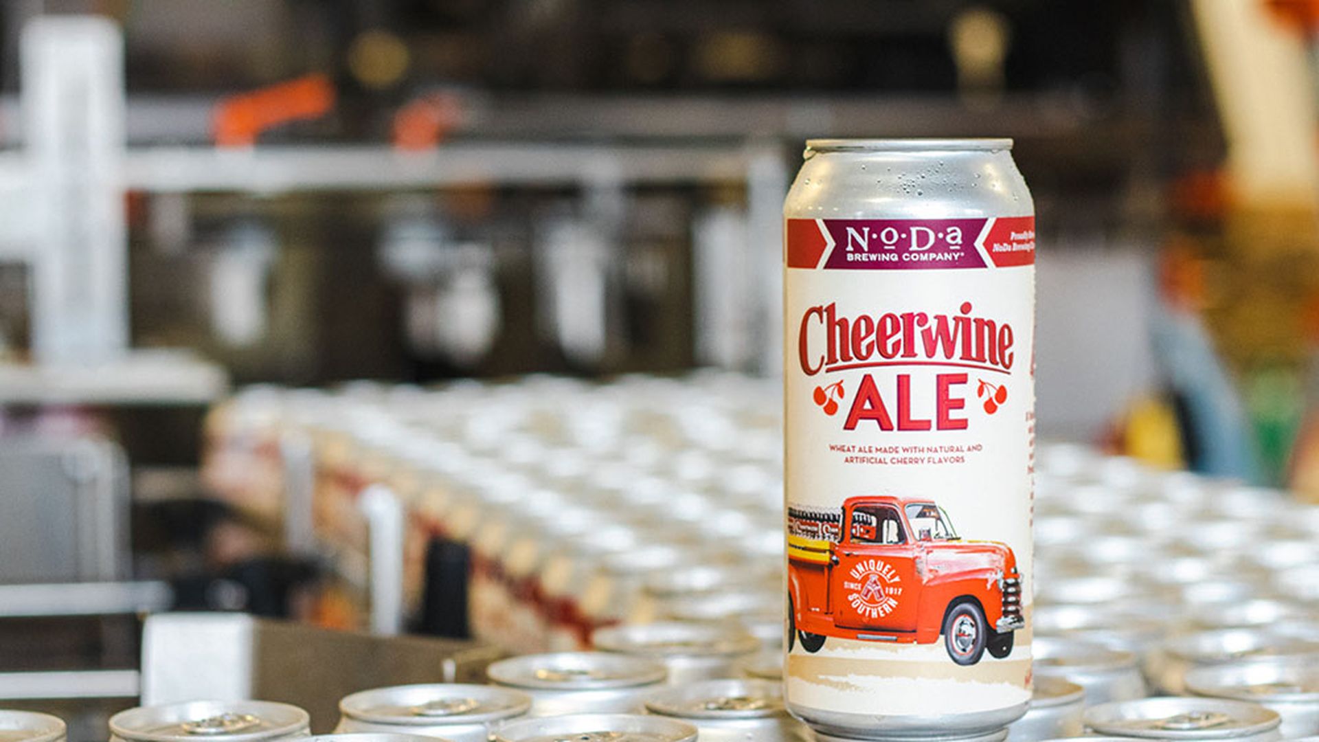 A can of Cheerwine Ale sitting on top of other cans of Cheerwine Ale.