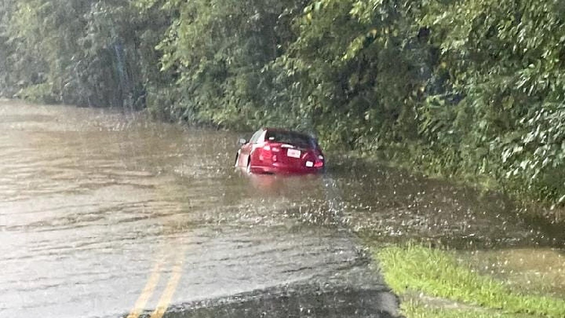 A car caught in floodwaters in Summerville, Georgia.