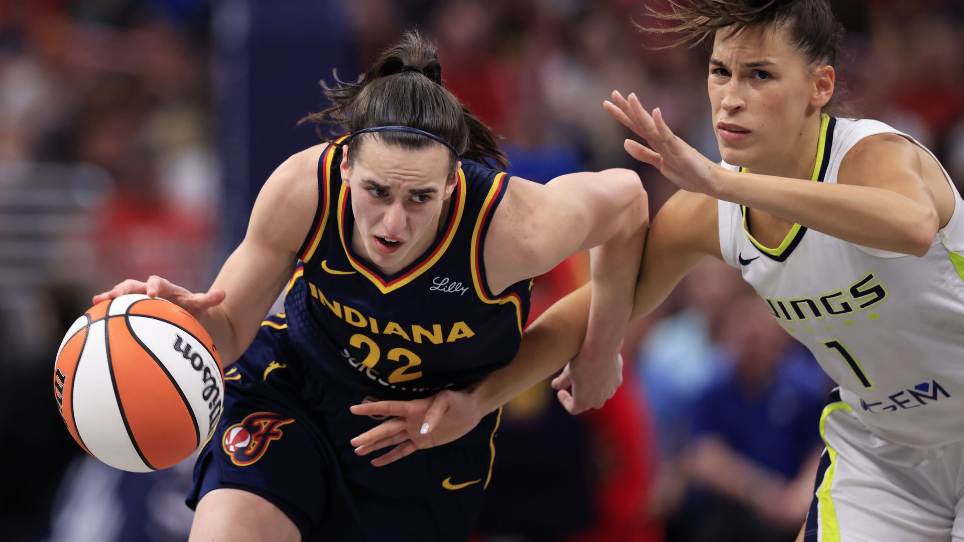 Caitlin Clark #22 of the Indiana Fever drives to the basket against Sevgi Uzun #1 of the Dallas Wings at Gainbridge Fieldhouse on September 15, 2024 in Indianapolis, Indiana. 