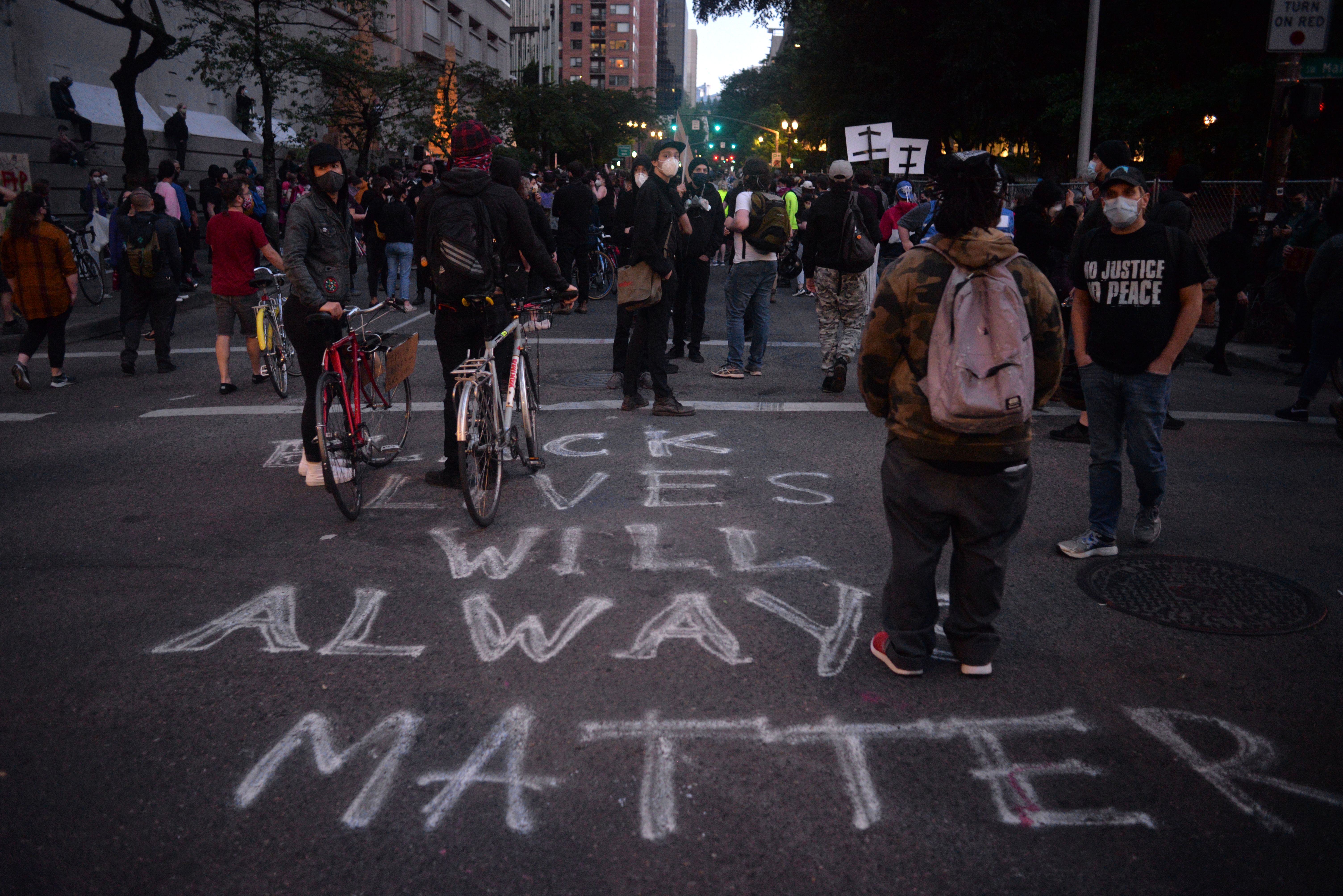 "black lives will always matter" spray painted on to the street