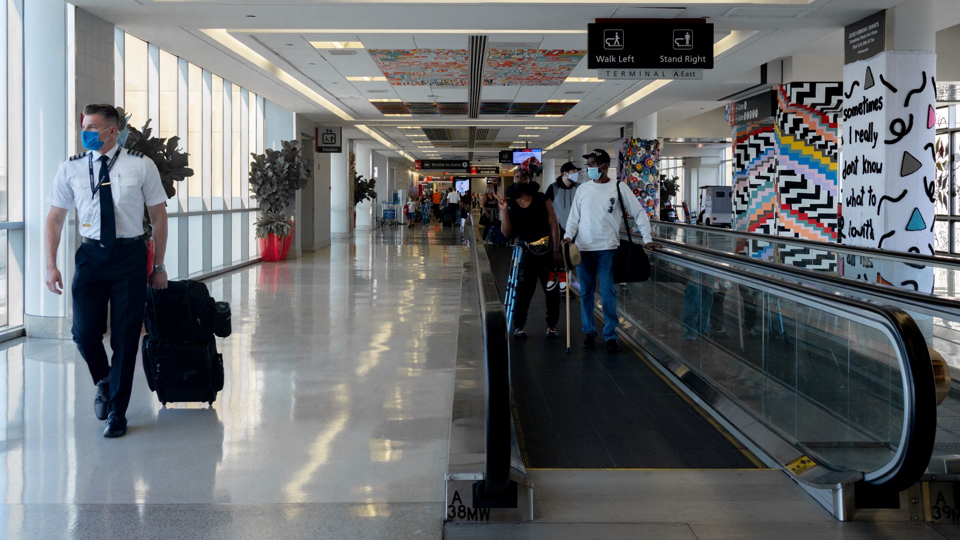 Travelers walk through Philadelphia International Airport. 