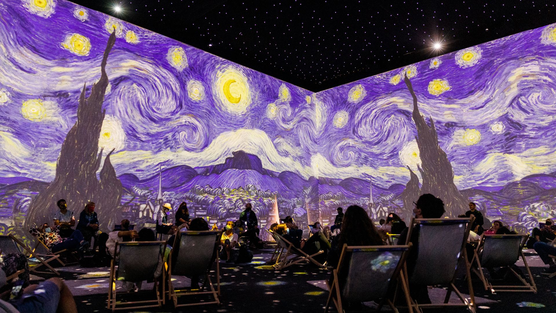 Visitors watch the immersive exhibition during the "Van Gogh: The Immersive Experience" press preview at Old Truman Brewery on July 29, 2021 in London, England. (Photo by Tristan Fewings/Getty Images)