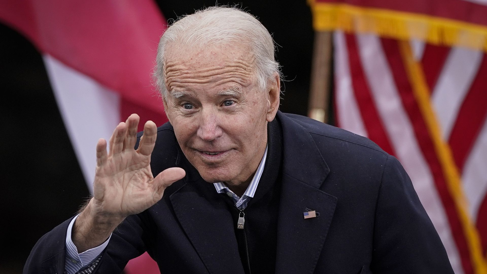 Joe Biden leans down a bit and waves 