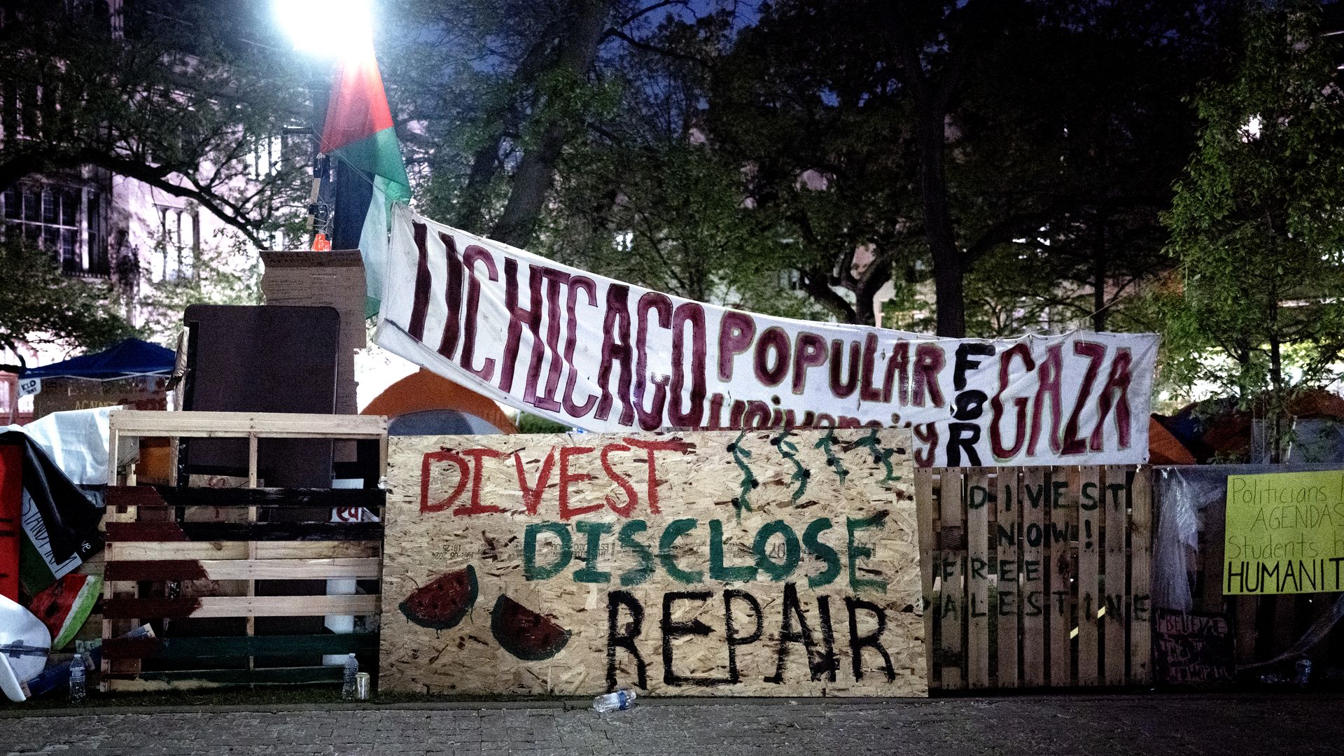 Photo of an encampment and tents on a campus quad