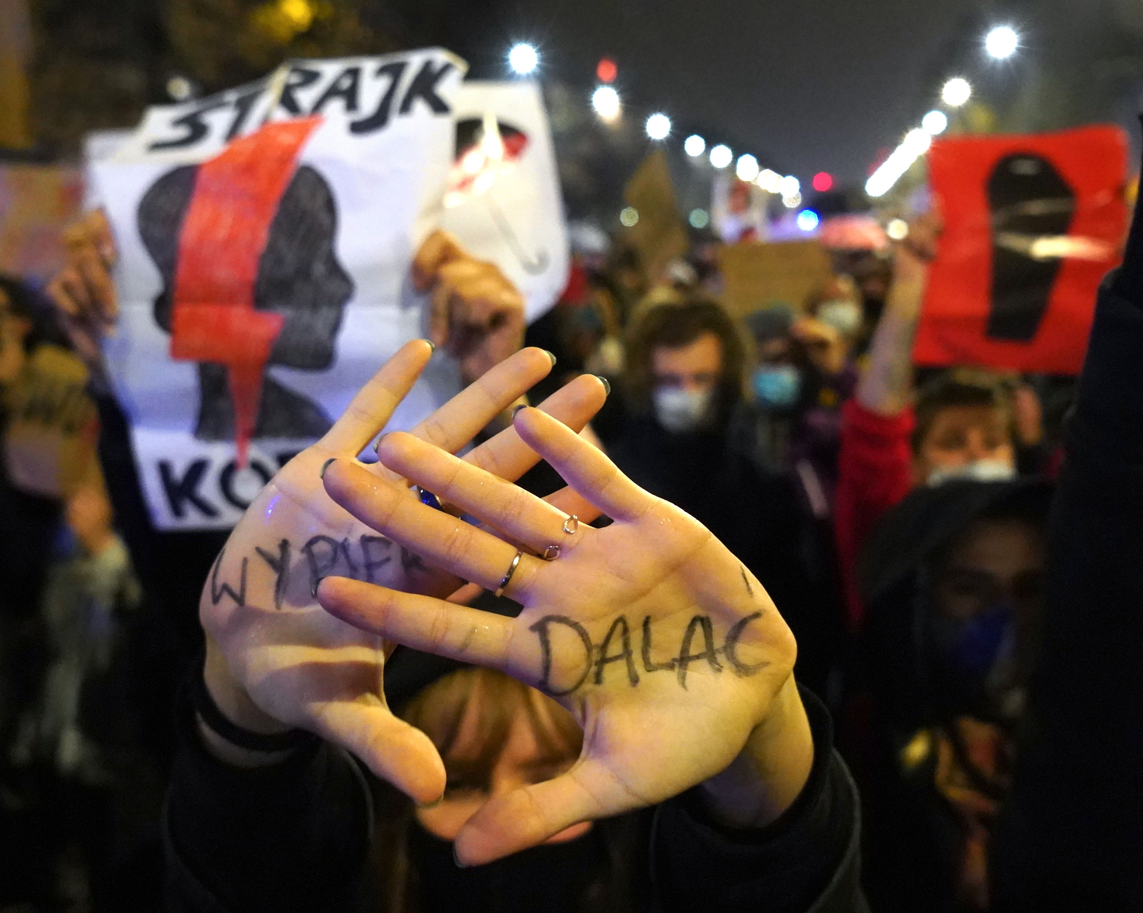 A protestor shows her hand written 'Get the fuck out of here' during a demonstration against a decision by the Constitutional Court on abortion law restriction, in Warsaw, Poland.