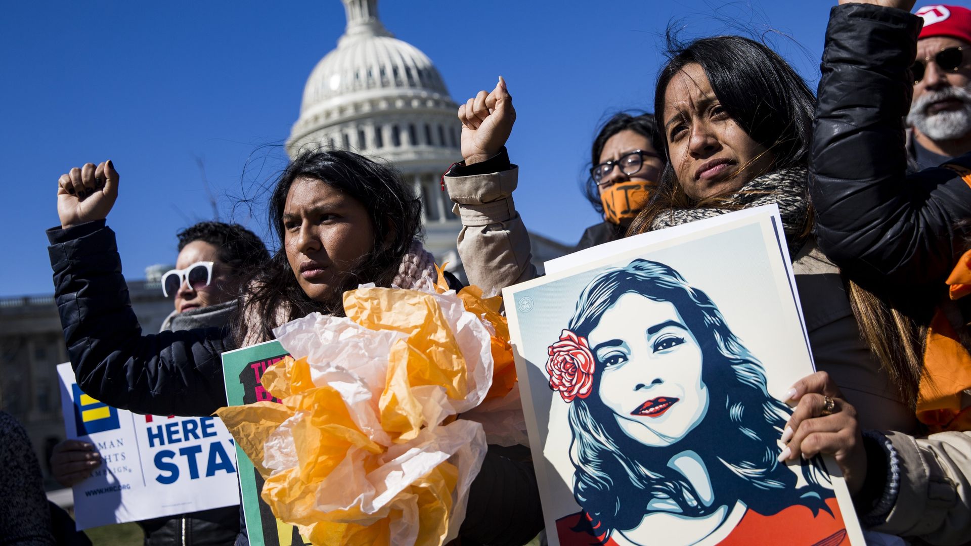 DACA protestors raise right fists