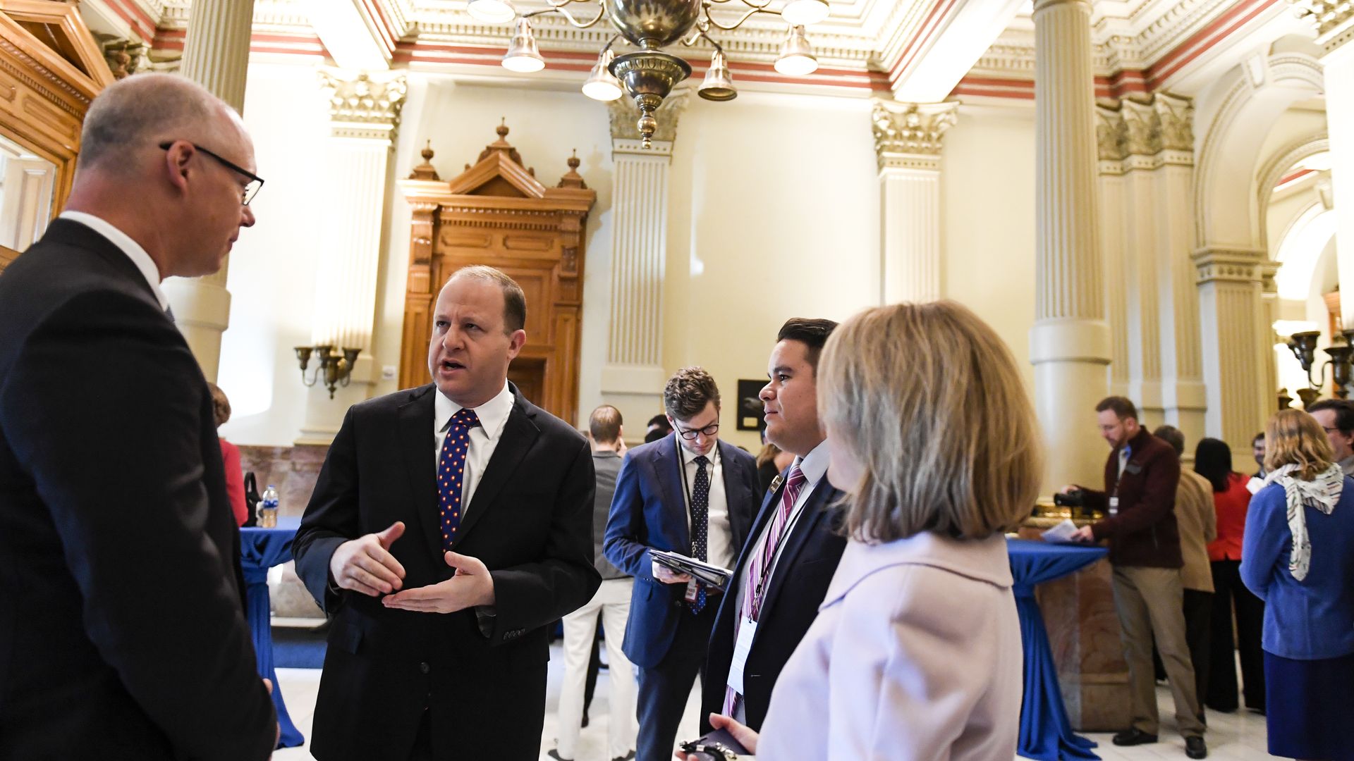 State Sen. Kevin Priola, left, talks to Gov. Jared Polis, center, in 2019. Photo: AAron Ontiveroz/The Denver Post via Getty Images