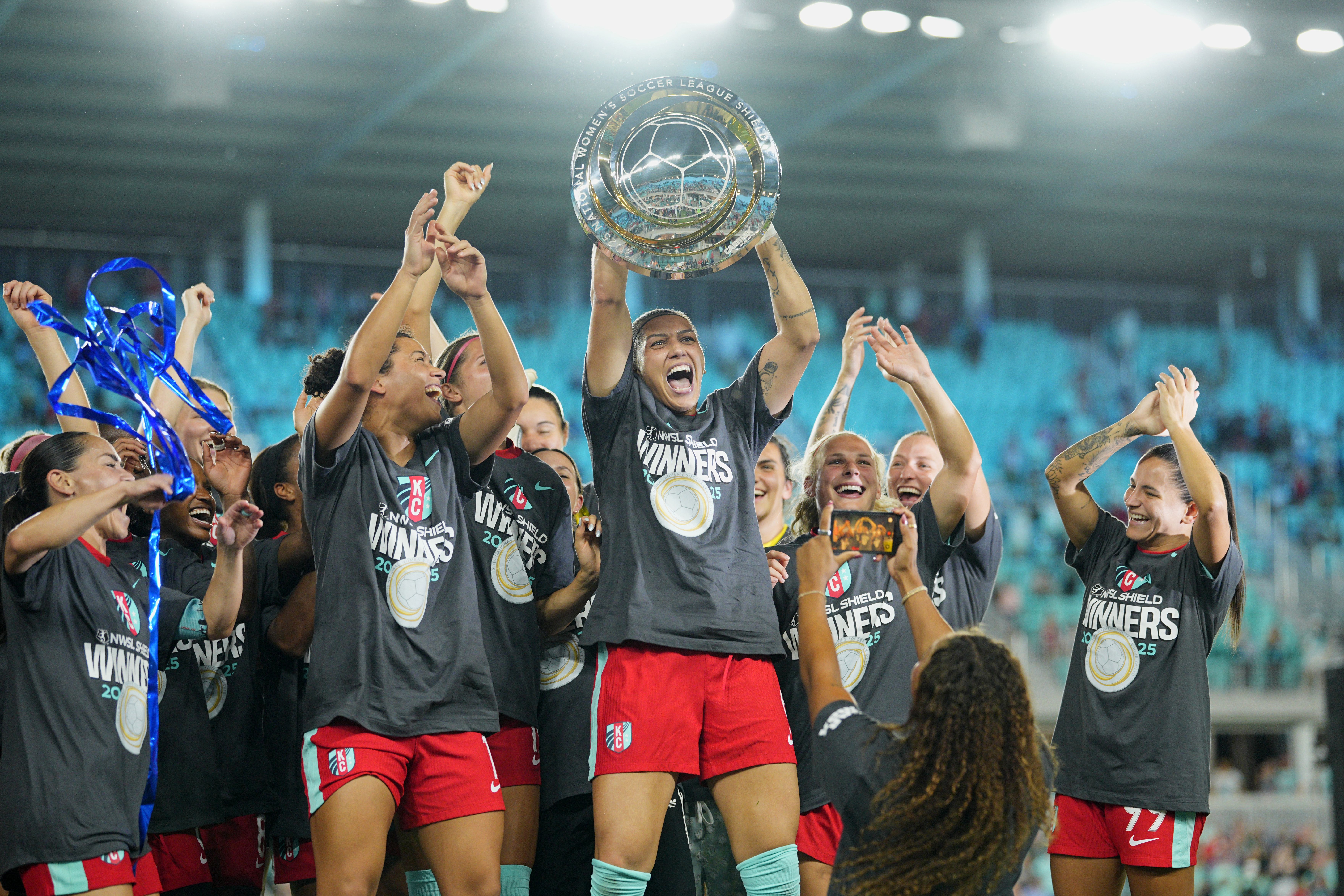 Bia Zaneratto #9 of Kansas City Current celebrates with the Shield after winning the NWSL match between Kansas City Current and Seattle Reign at CPKC Stadium on September 20, 2025, in Kansas City, Missouri. Kansas City Current became the fastest team in league history to win the NWSL Shield