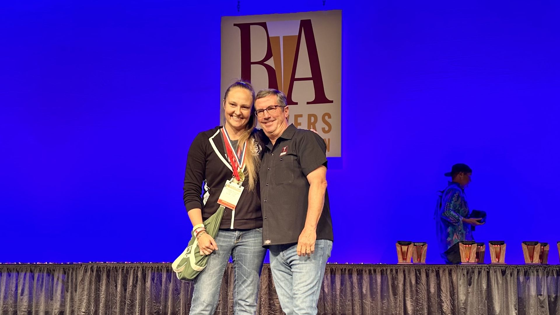 Brewery owners pose with award.