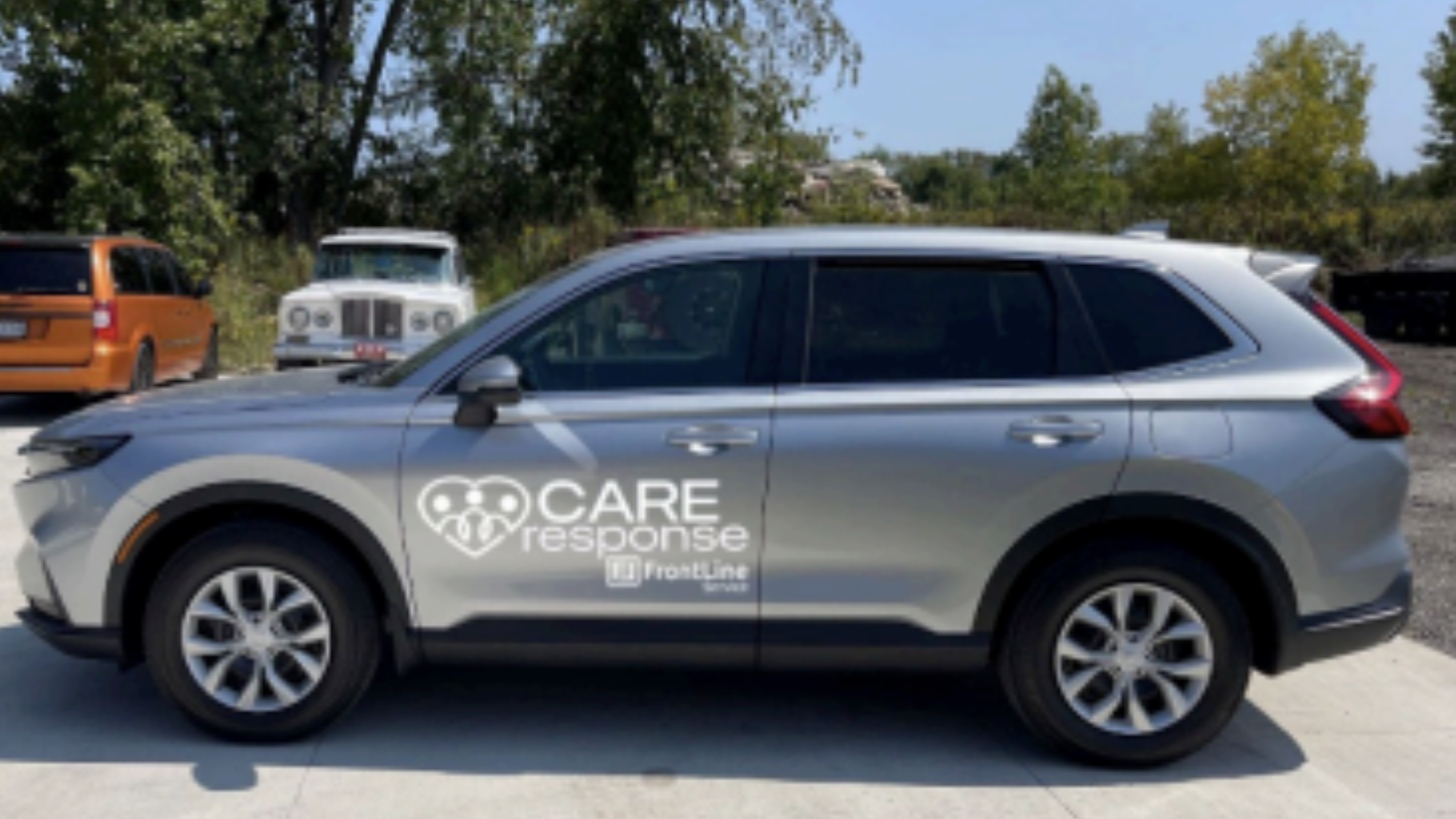 A silver Honda CR-V with "Care Response" in white on the side