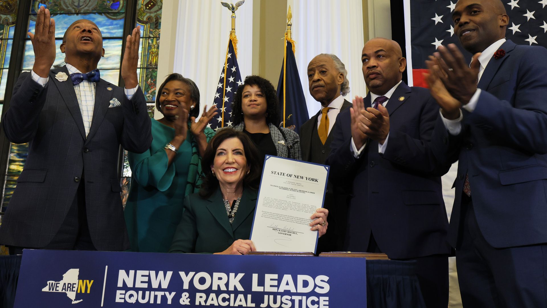  New York Gov. Kathy Hochul holds up signed legislation creating a commission for the study of reparations in New York on December 19, 2023.