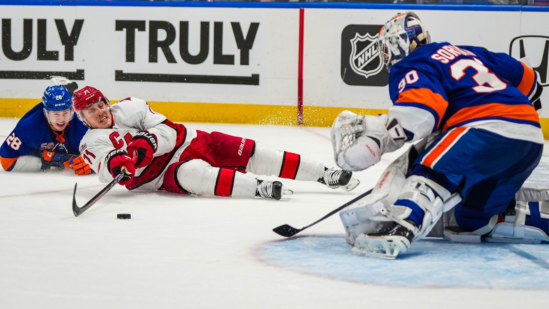 Carolina Hurricanes v New York Islanders - Game Three ELMONT, NEW YORK - APRIL 21: Jesper Fast #71 of the Carolina Hurricanes falls to the ice as he drives on Ilya Sorokin #30 of the New York Islanders during the third period in Game Three of the First Round of the 2023 Stanley Cup Playoffs at UBS A